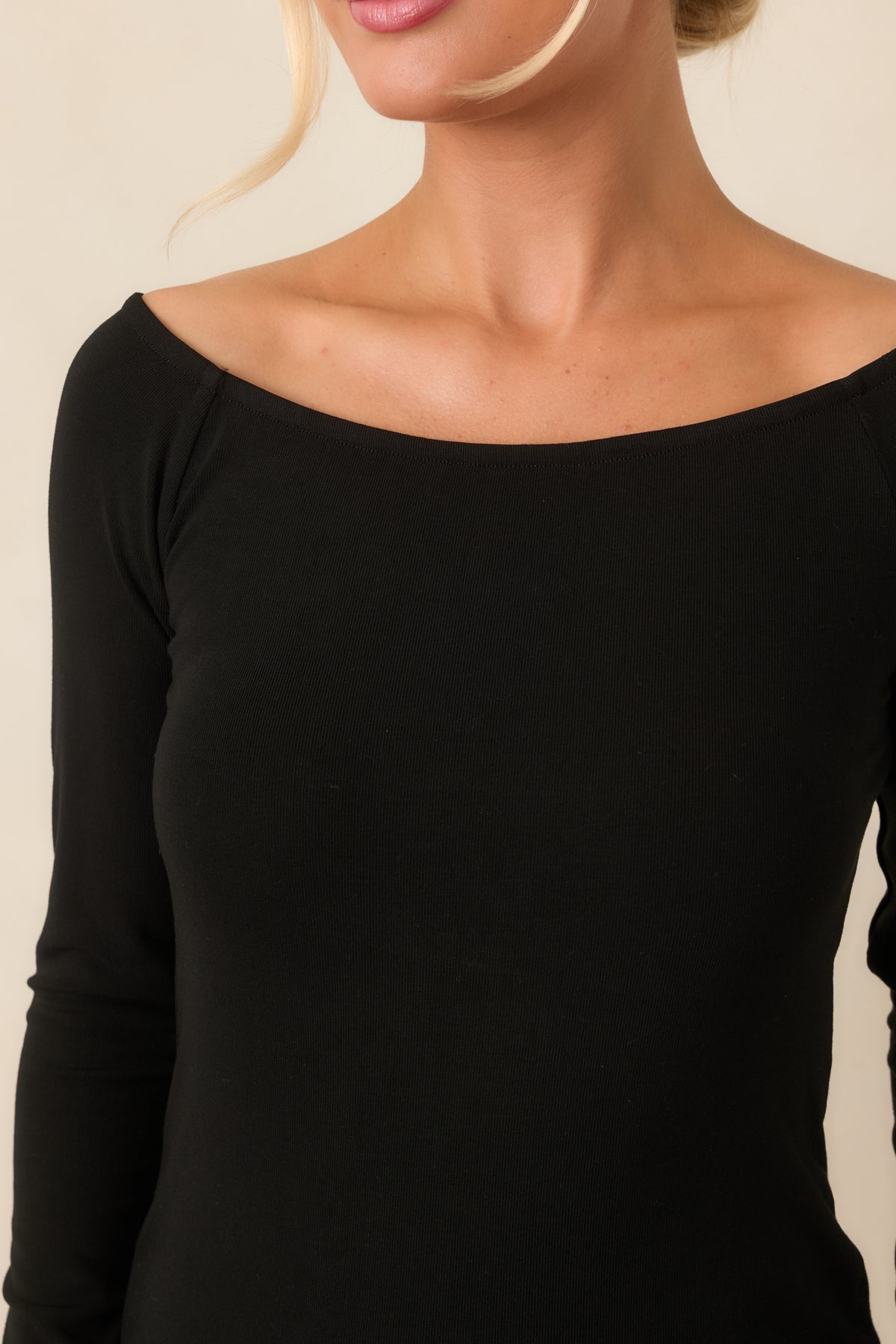 Close detail of the soft stretchy fabric and wide boat neckline.