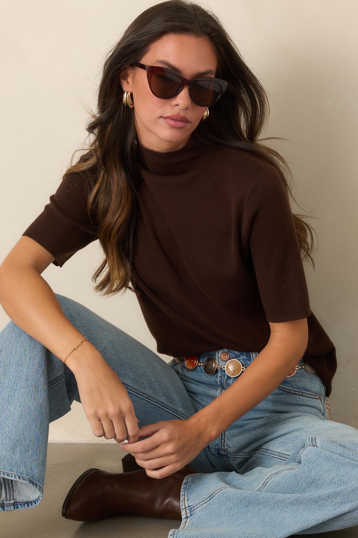 Softly structured top showcasing the high turtleneck and smooth short-sleeve design.