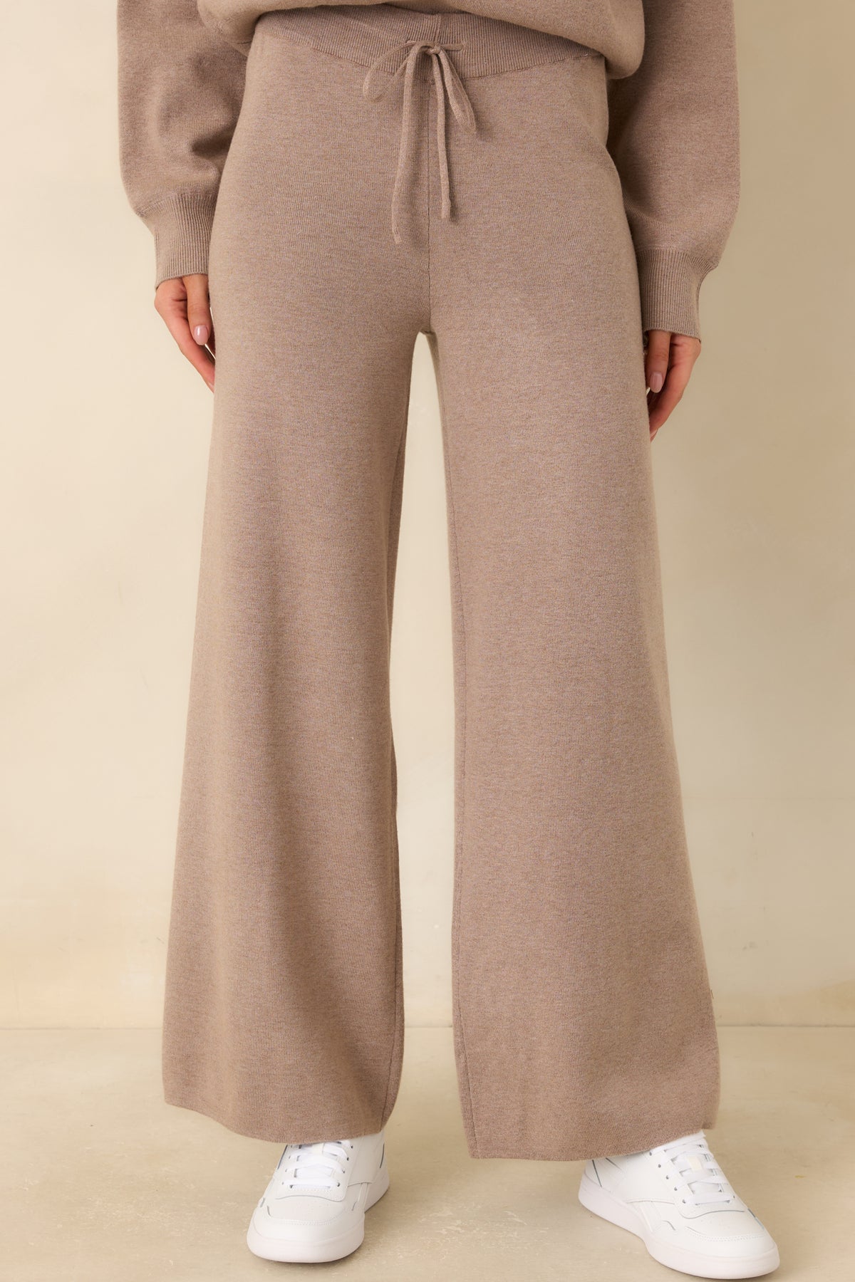 Soft sweater-knit pants featuring roomy side seam pockets and a relaxed hip fit.