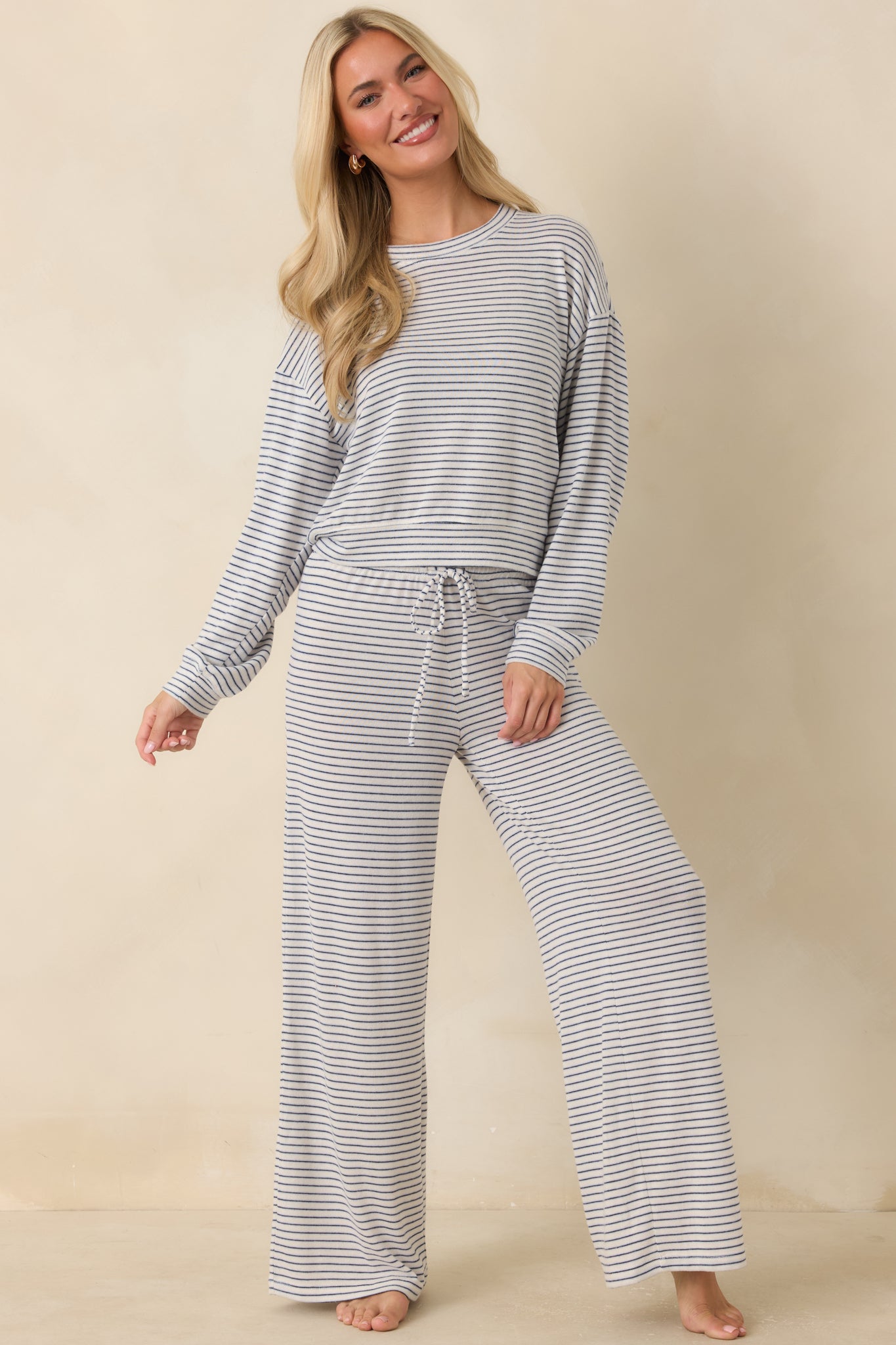 Ultra-soft sweater knit pants designed with a flowing wide leg shape and timeless navy stripe pattern.
