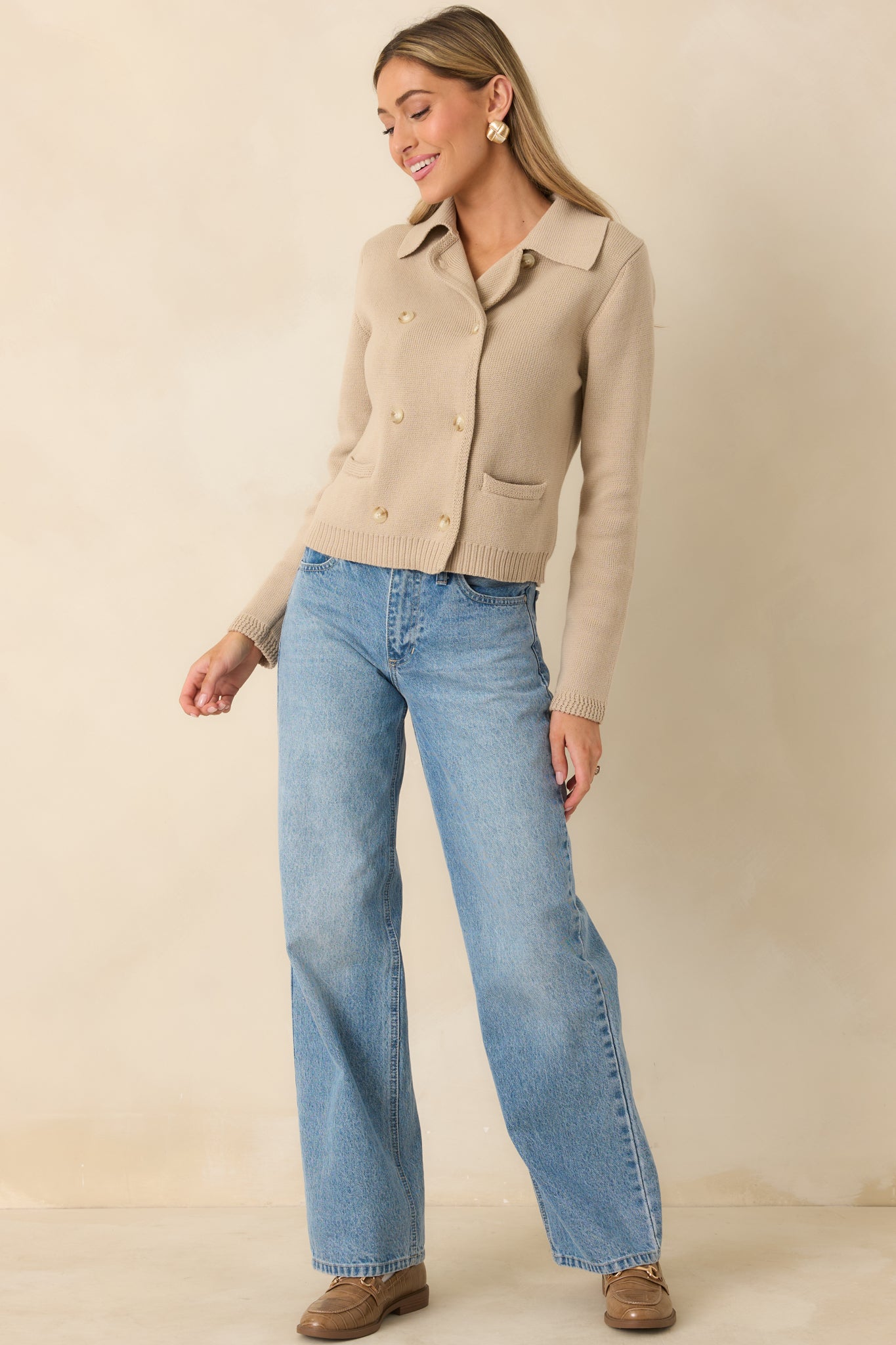 Soft taupe cardigan showing the button-front design, front patch pockets, and ribbed hem in a comfortable layered shape.