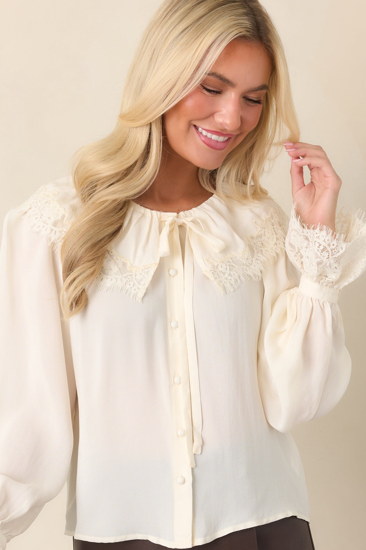Soft viscose blouse featuring tonal lace across the front yoke and fabric-covered buttons.