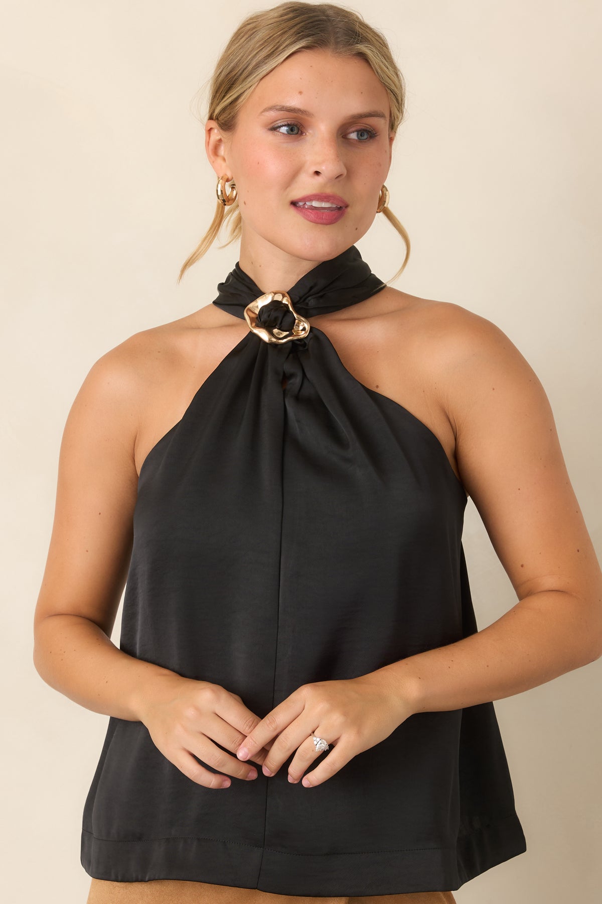 Softly draped top highlighting the sleeveless cut and halter neckline.