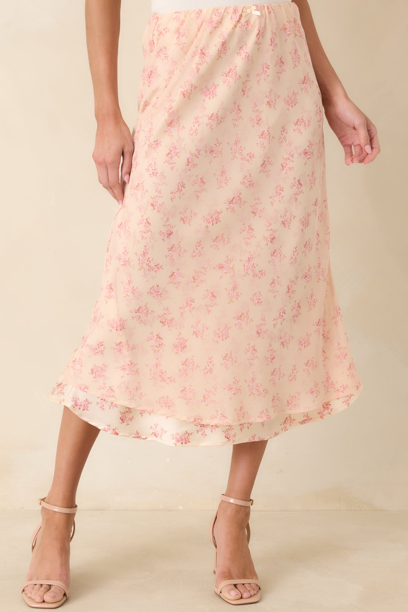 Softly gathered chiffon skirt featuring a romantic pink floral pattern and gentle tiering for added dimension.
