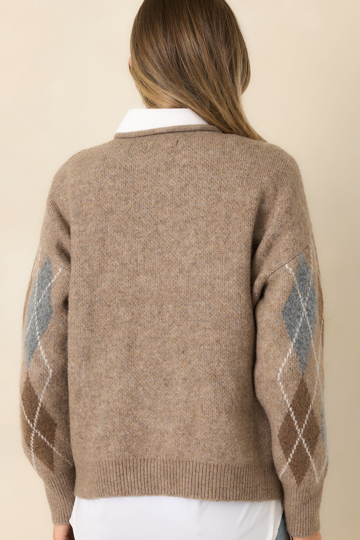 Solid taupe knit back with dropped shoulders, long sleeves, and a ribbed hem.