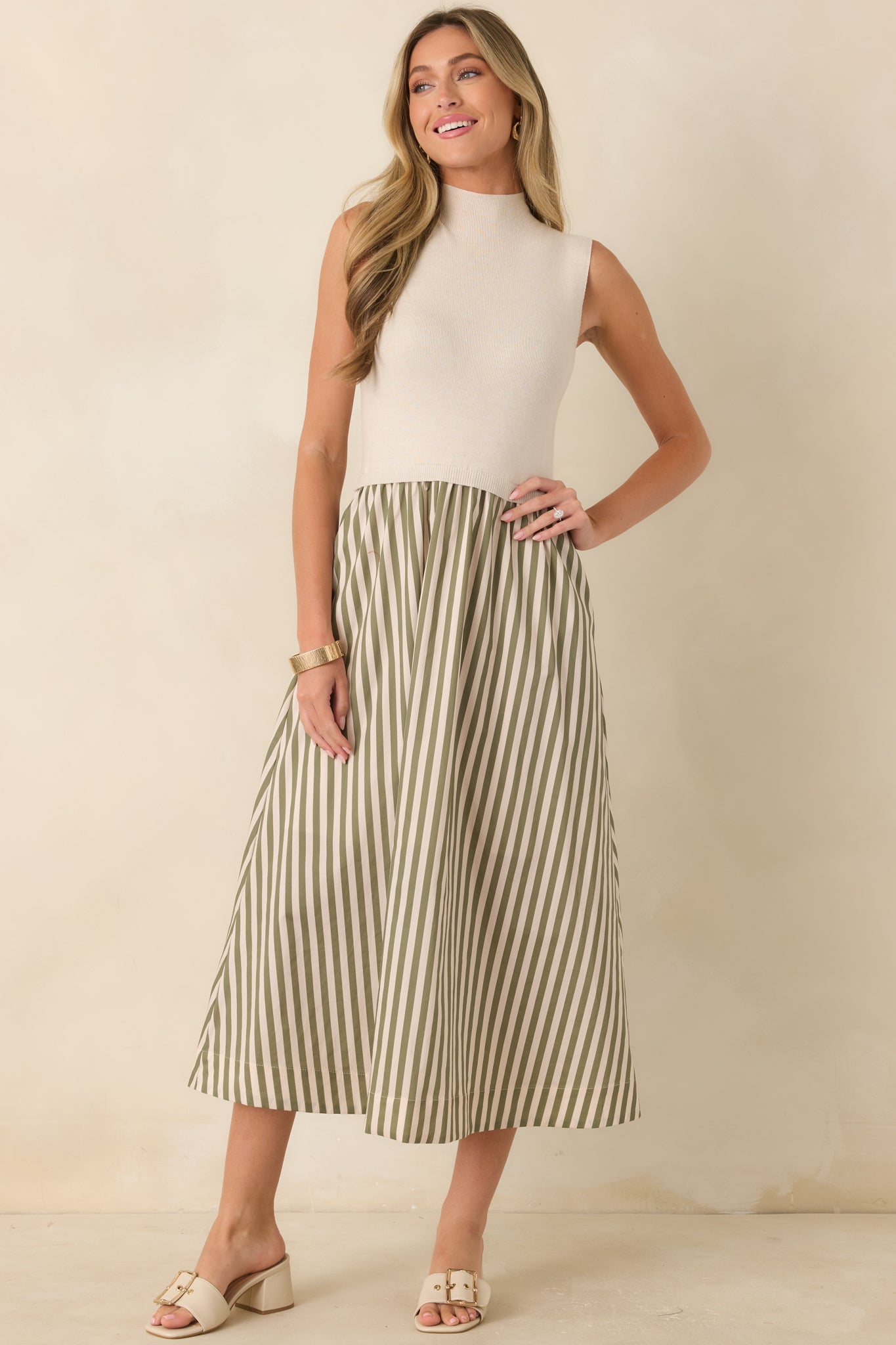 Sophisticated knit midi dress combining a neutral ecru bodice with sage green stripes for a timeless, elevated look.