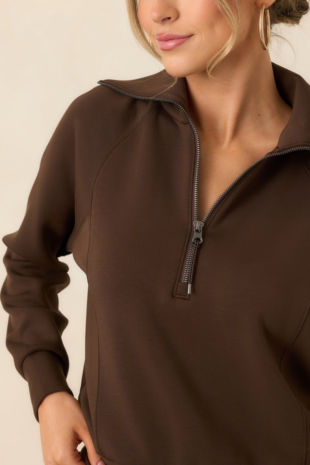 Close detail of the pullover’s half-zip closure, oversized collar, and silky-smooth spacer fabric.