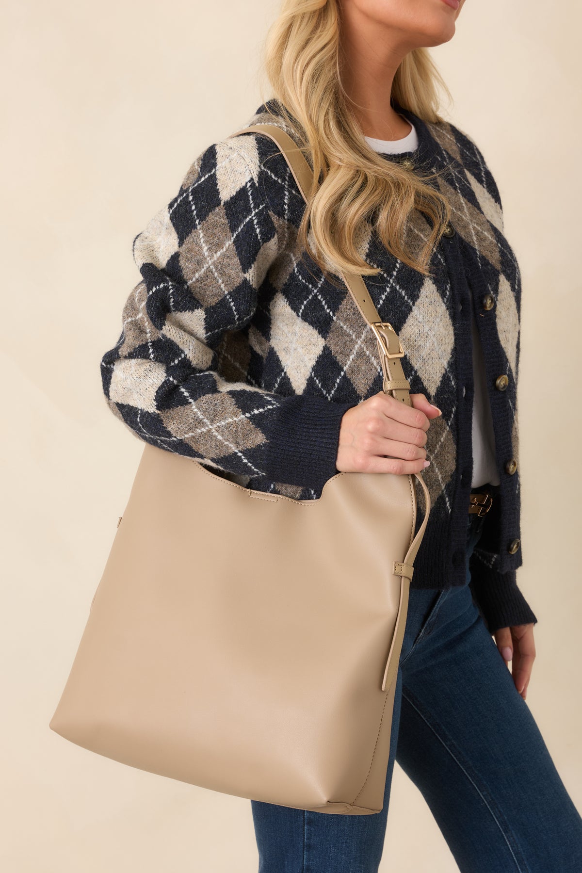 Spacious carryall handbag featuring an adjustable shoulder strap and a coordinating zip pouch.