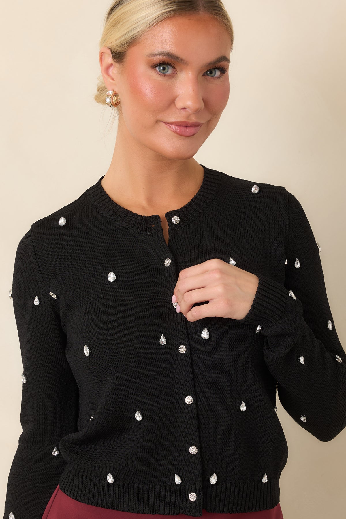 Button-front cardigan with sparkling embellishments and a softly cropped hemline.
