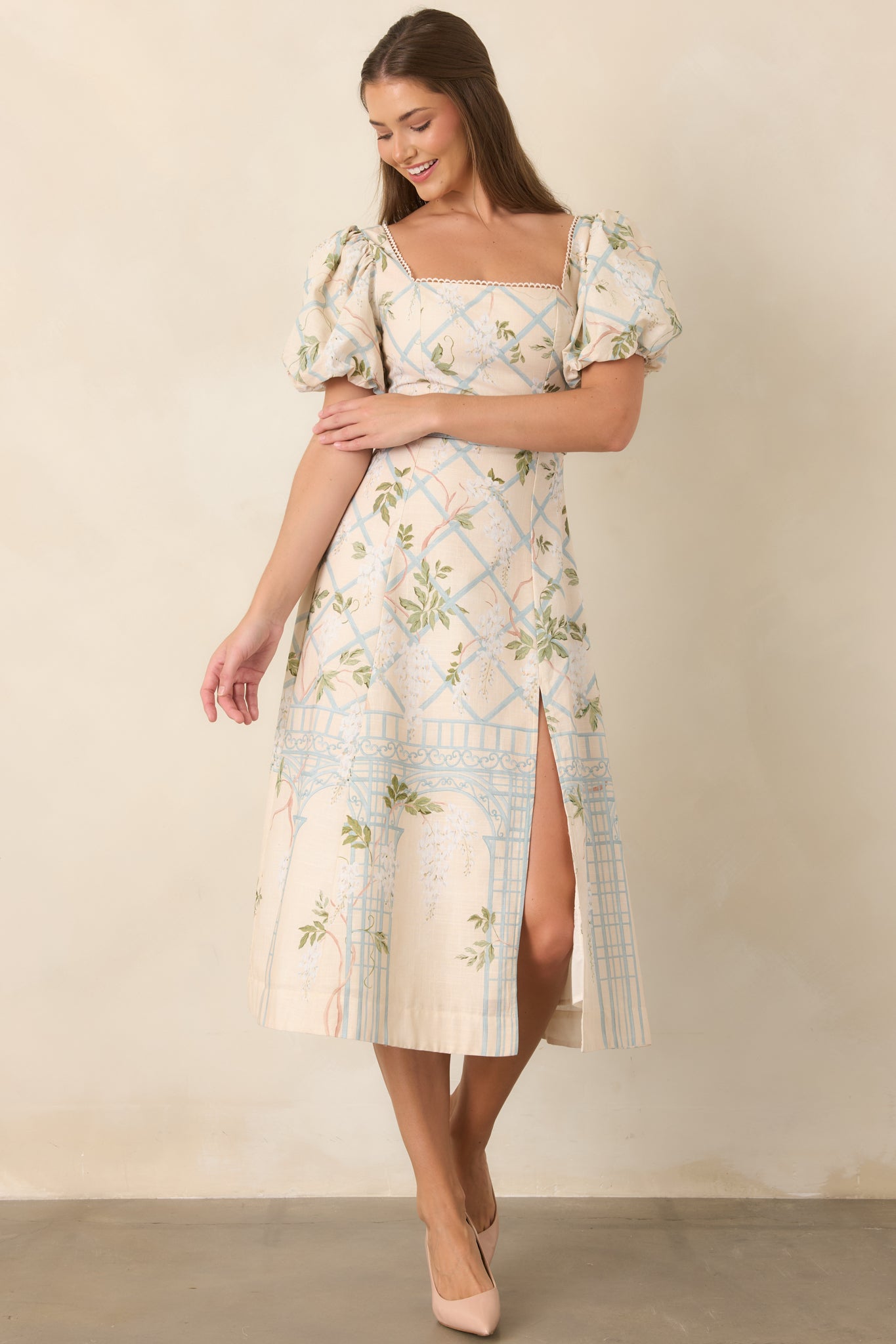 Square-neck dress with defined waist and flowing midi skirt