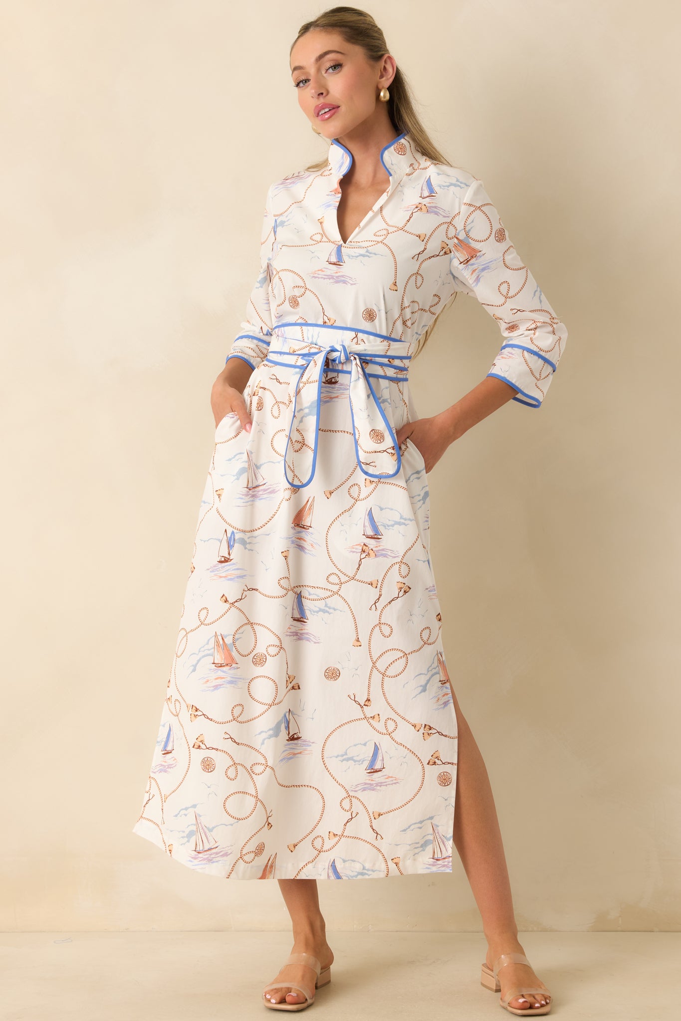 Maxi dress featuring a polished stand collar, convenient side pockets, blue piping details, and effortless movement.