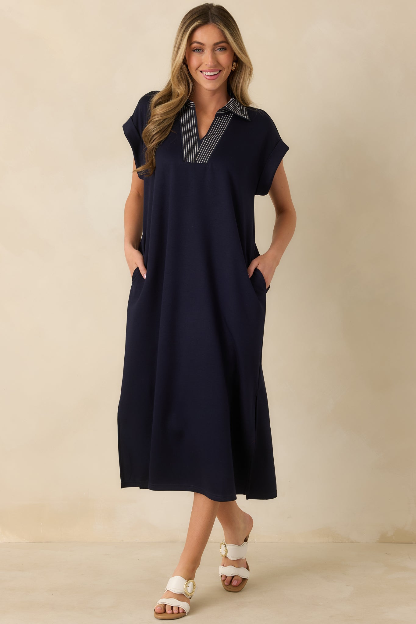 Navy straight-cut midi dress showcasing contrast stitching along the neckline and a smooth, comfortable knit feel.