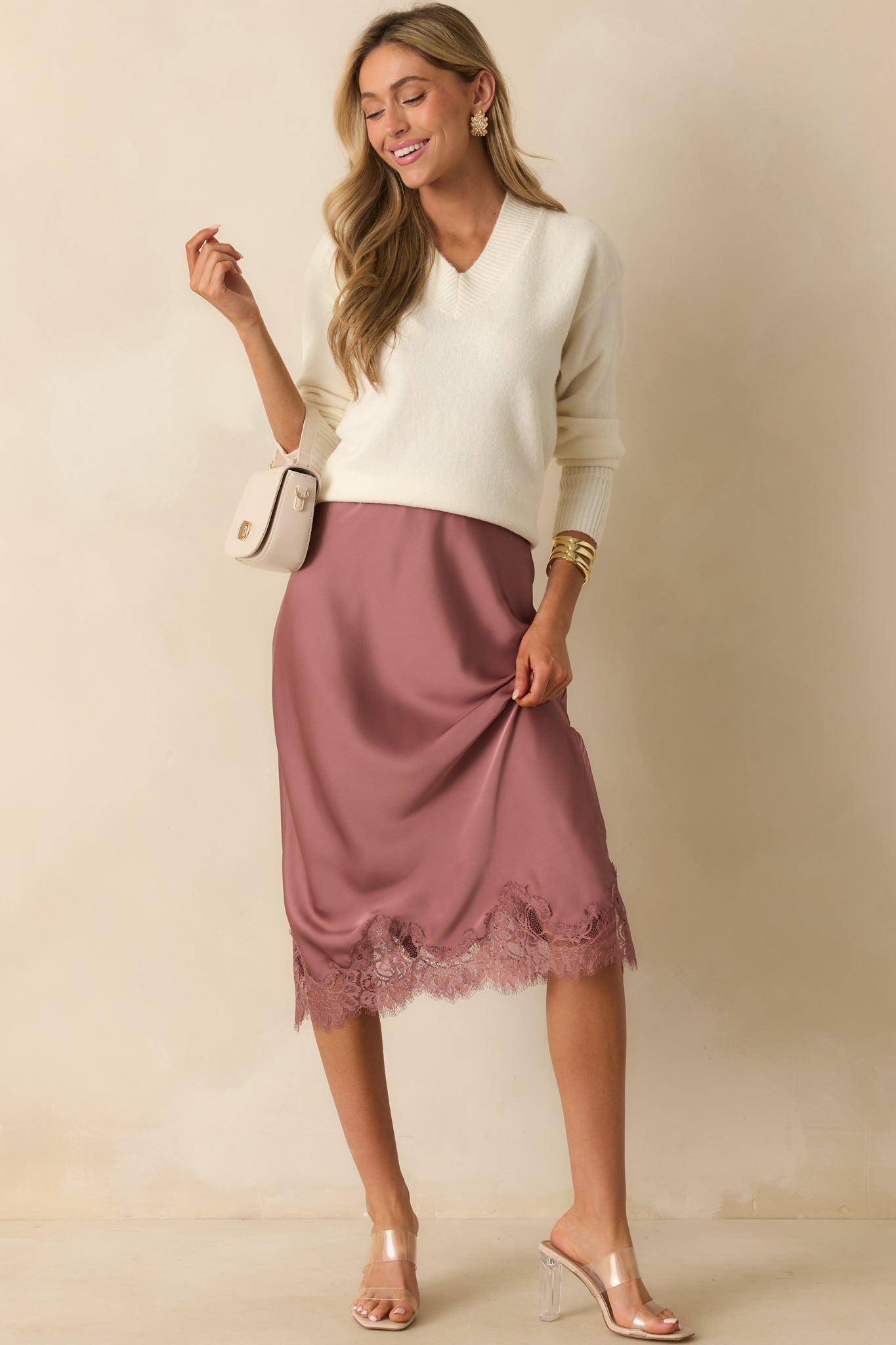Straight-cut rose pink skirt with elastic waistband and scalloped eyelash lace trim along the hem.