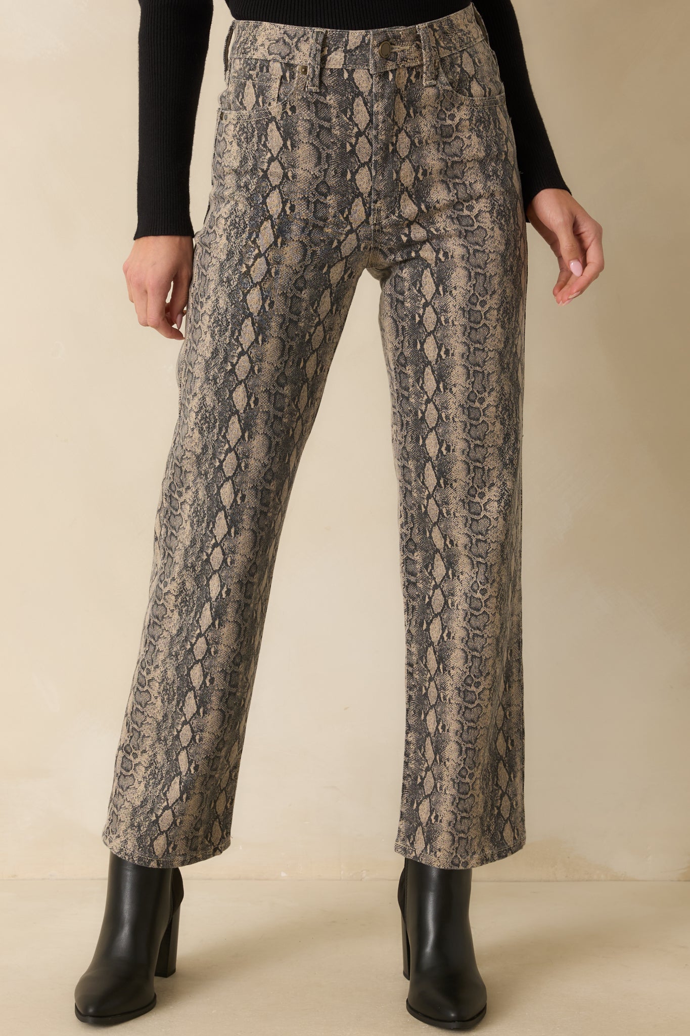 Detail of the straight-leg cut and textured snakeskin pattern in light stretch denim.