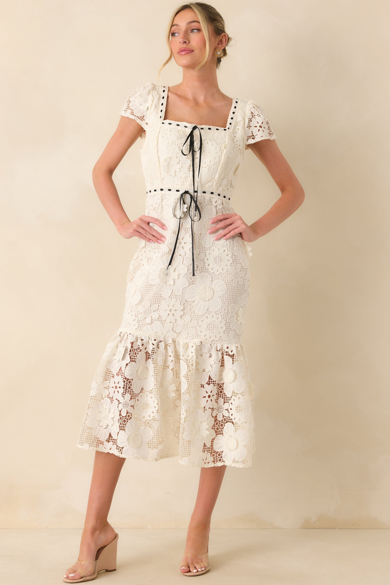 A straight-on view emphasizing the open embroidered sleeves and curve-hugging mermaid shape.