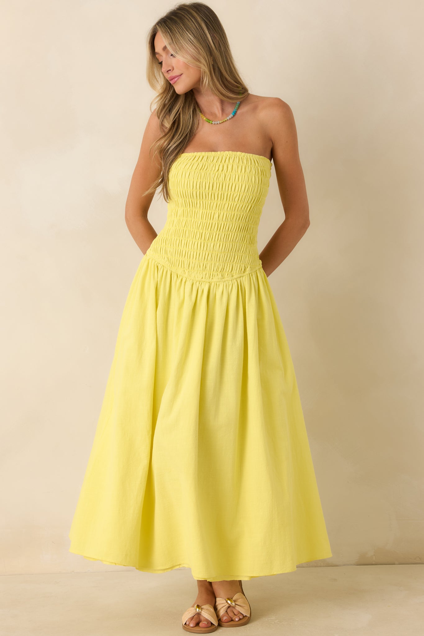Lightweight cotton maxi dress showcasing a strapless neckline, elastic bodice, and airy gathered skirt silhouette.