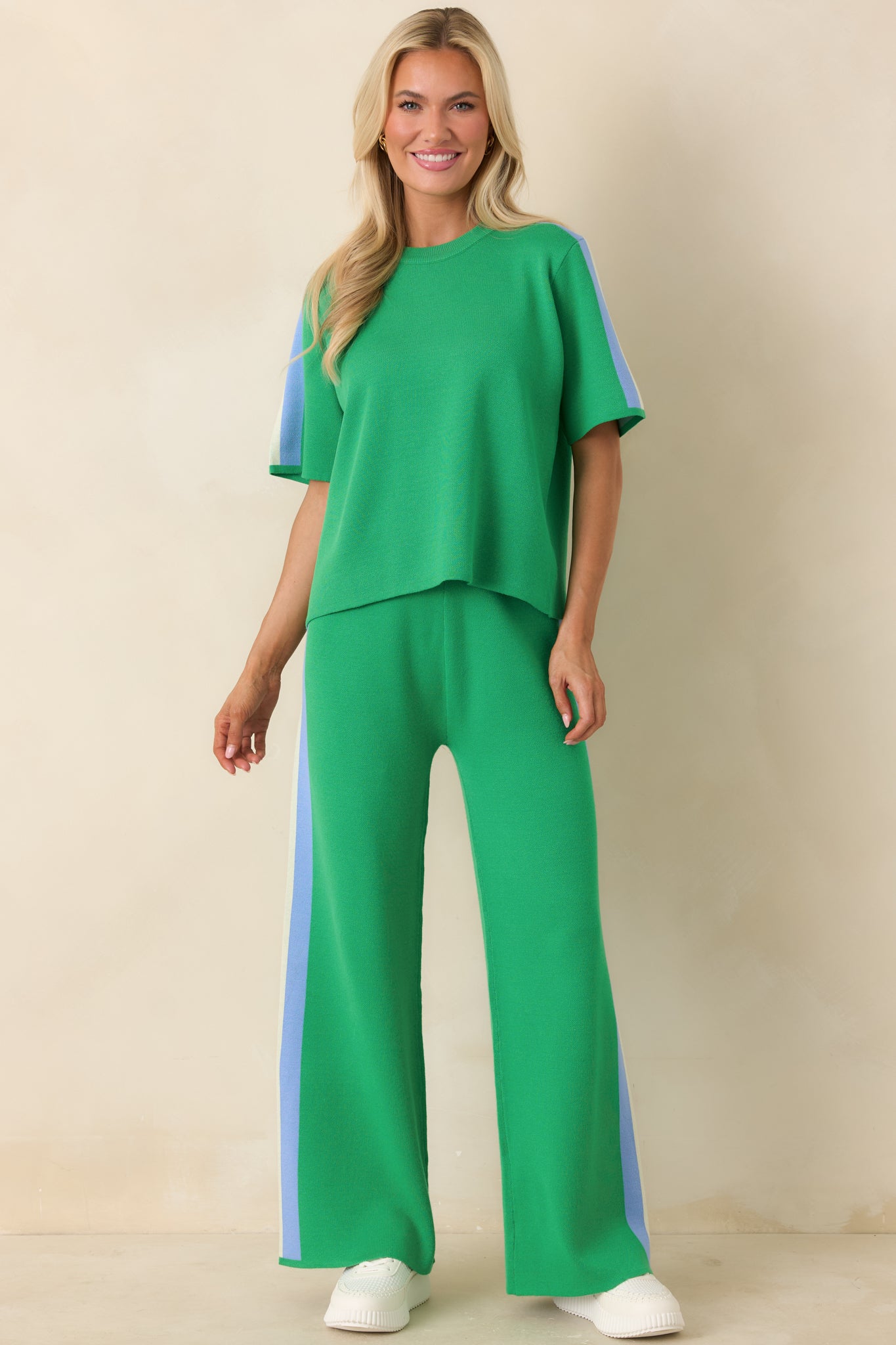 Streamlined green knit pants with sporty side stripe and elongating wide-leg cut.