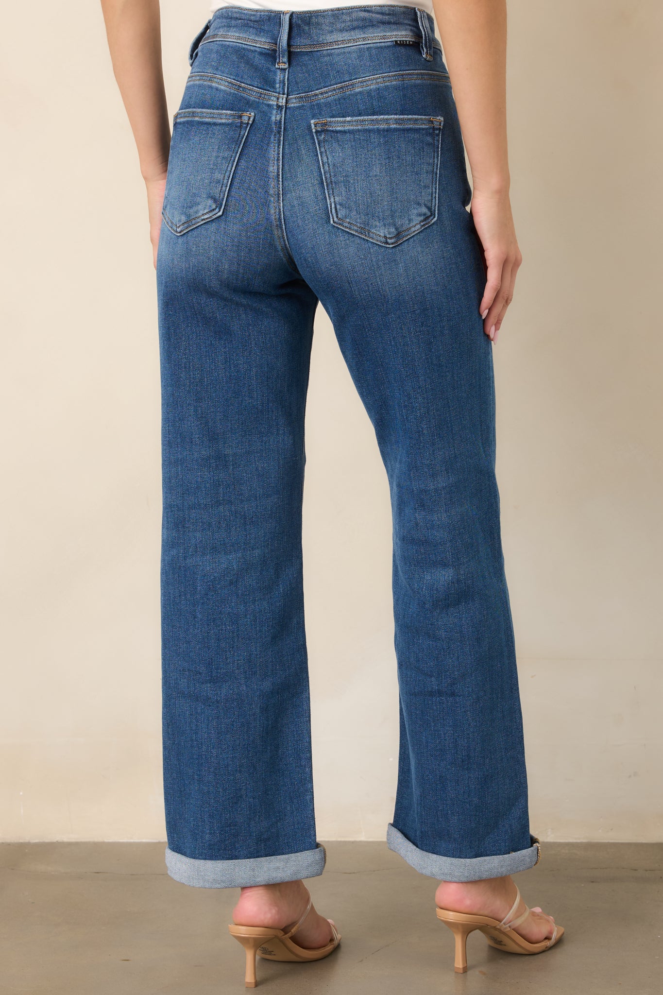 Rear view of the stretch denim jeans showcasing two functional back pockets, belt loops, subtle fading, and a comfortable everyday fit.
