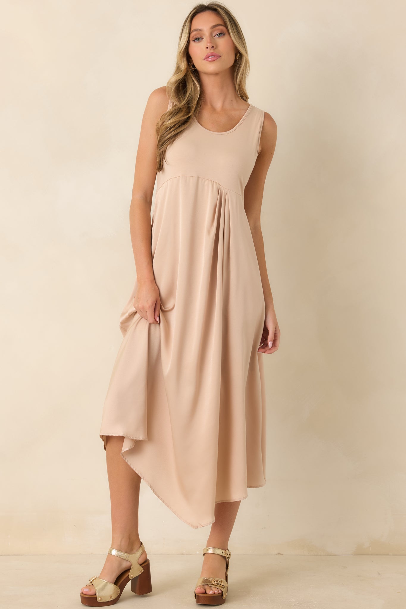 Front-facing view emphasizing the contrast between the stretch-knit bodice and flowing satin skirt on the champagne midi dress.