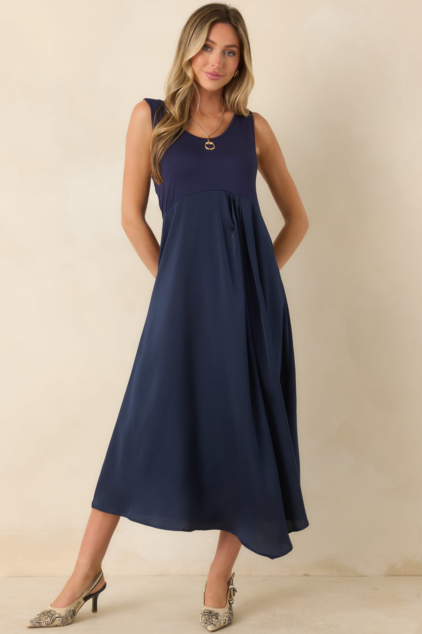 Stretch-knit and satin midi dress featuring a scoop neckline, sleeveless design, and a graceful lined skirt with fluid movement.