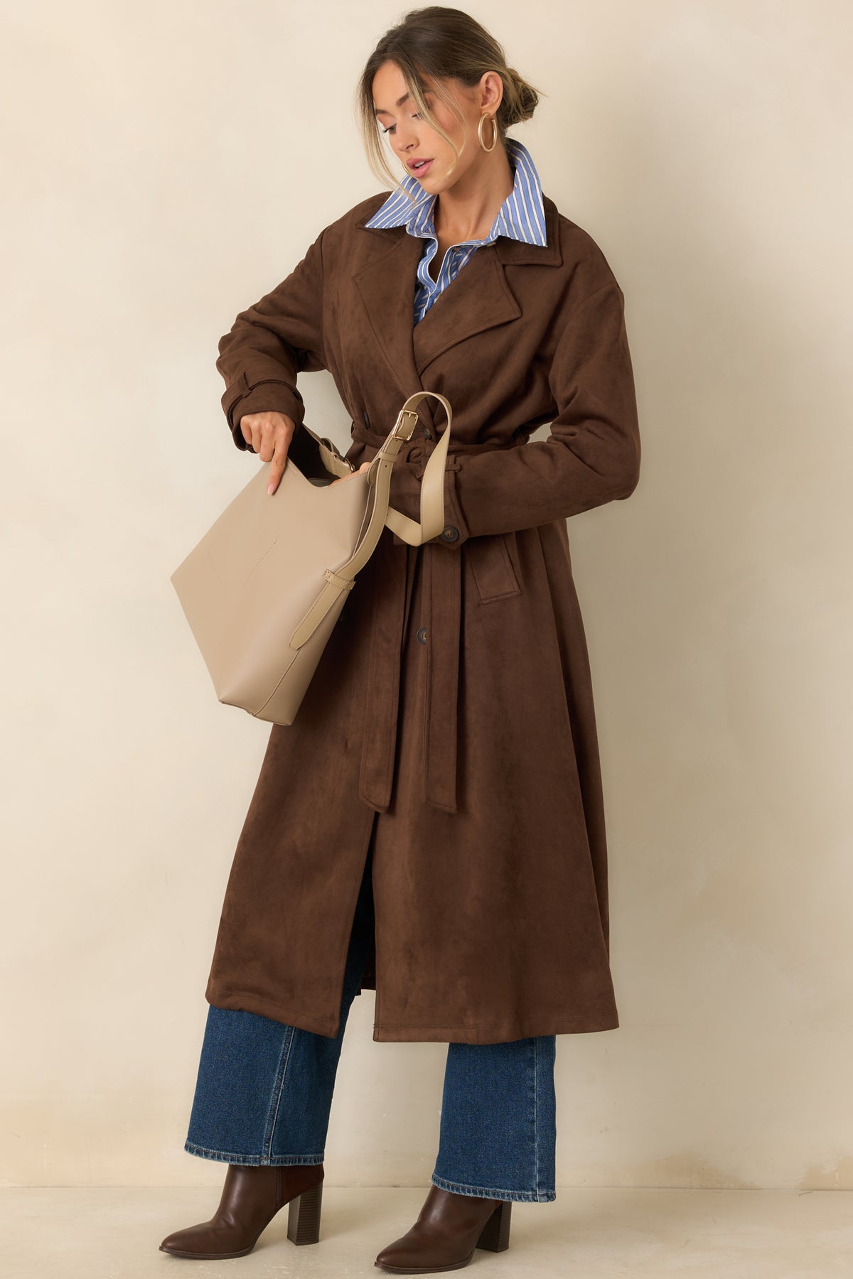 Stretch coat features a tailored longline shape, notched lapels, and a self-tie belt that defines the waist.