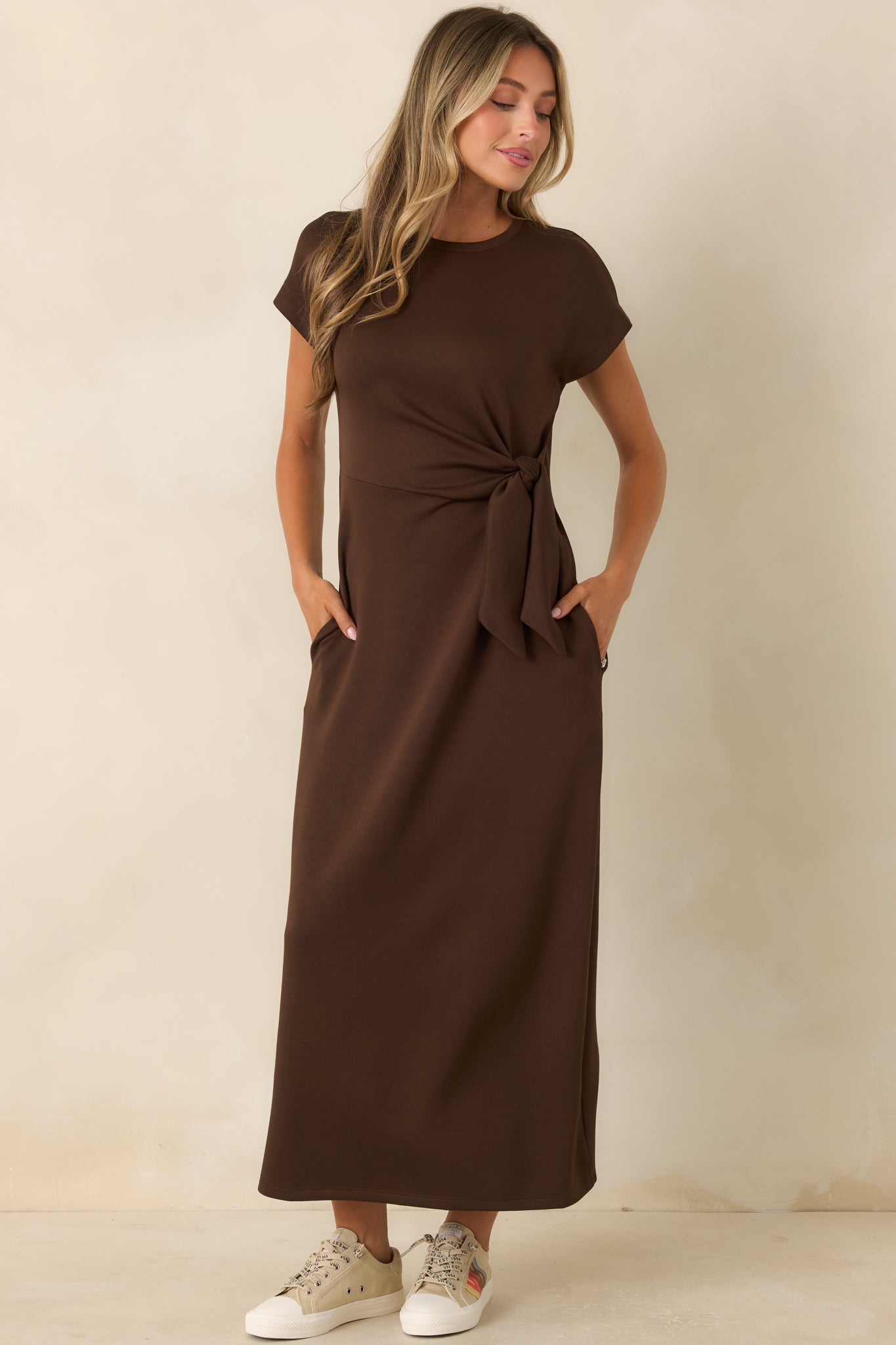 Stretch midi dress showcasing clean lines, a defined waist knot, and a polished feminine shape.