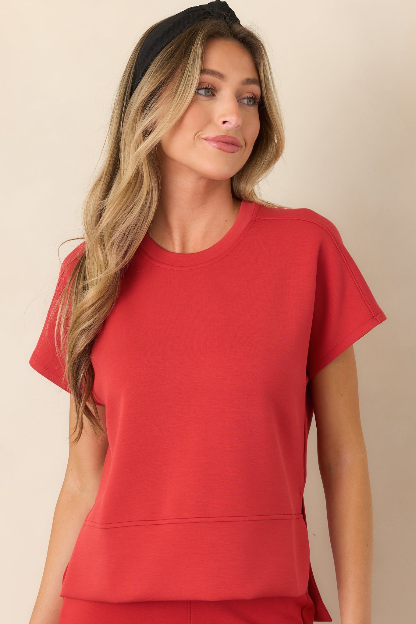 Close view of the stretch top highlighting its classic crew neckline, smooth fabric, and relaxed drape.