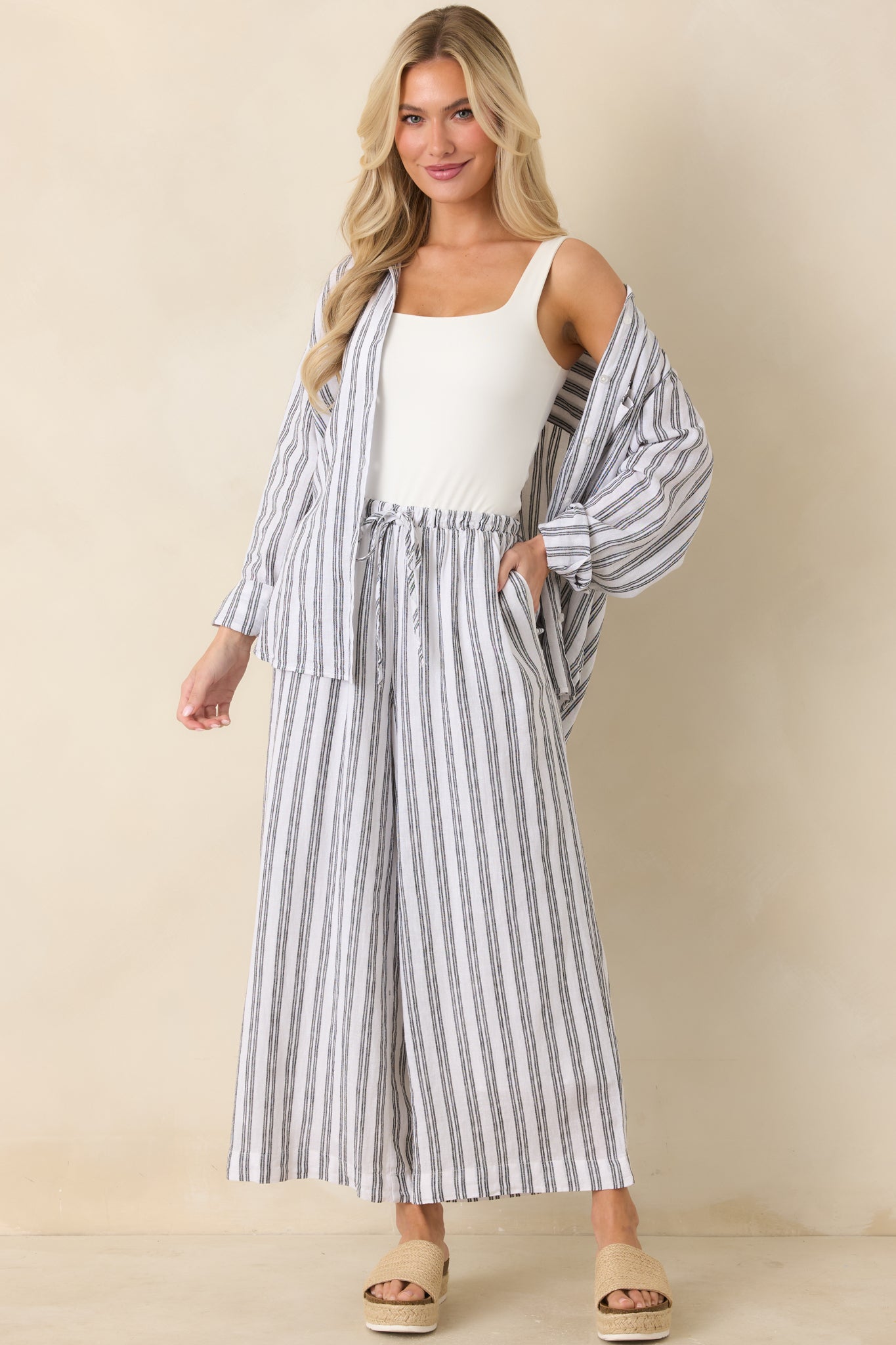 Striped button-up top featuring long sleeves, classic collar, and easy relaxed silhouette.