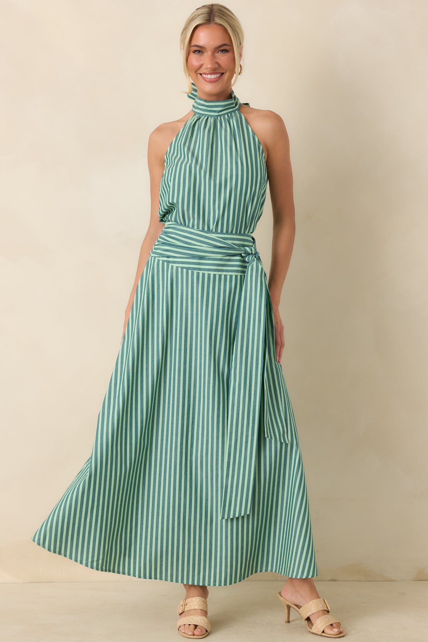 Lightweight cotton halter top featuring alternating dark green and mint stripes, a high neckline, soft gathered detailing, and a relaxed flowing silhouette.