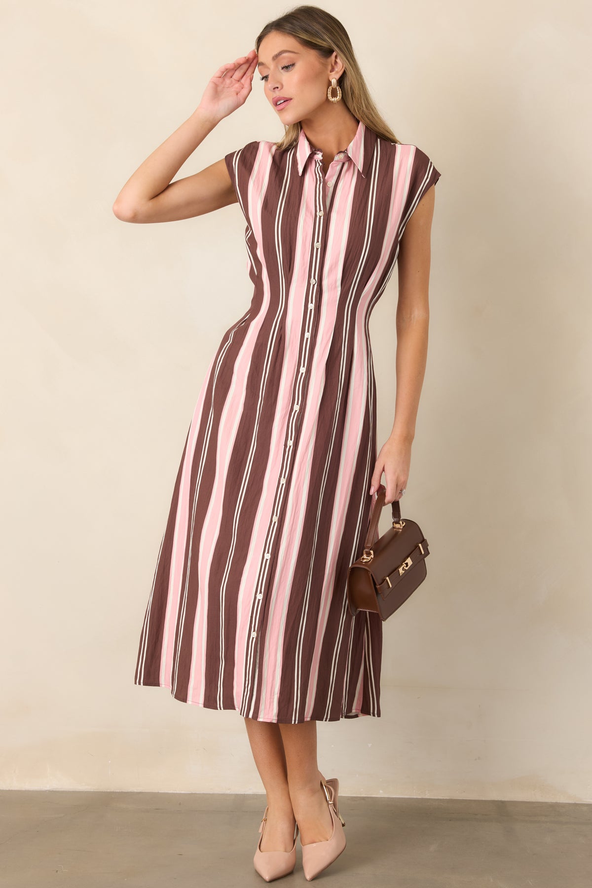 Vertical striped shirt dress designed with tailored princess seams, a defined waist, gently flared skirt, and practical side pockets.