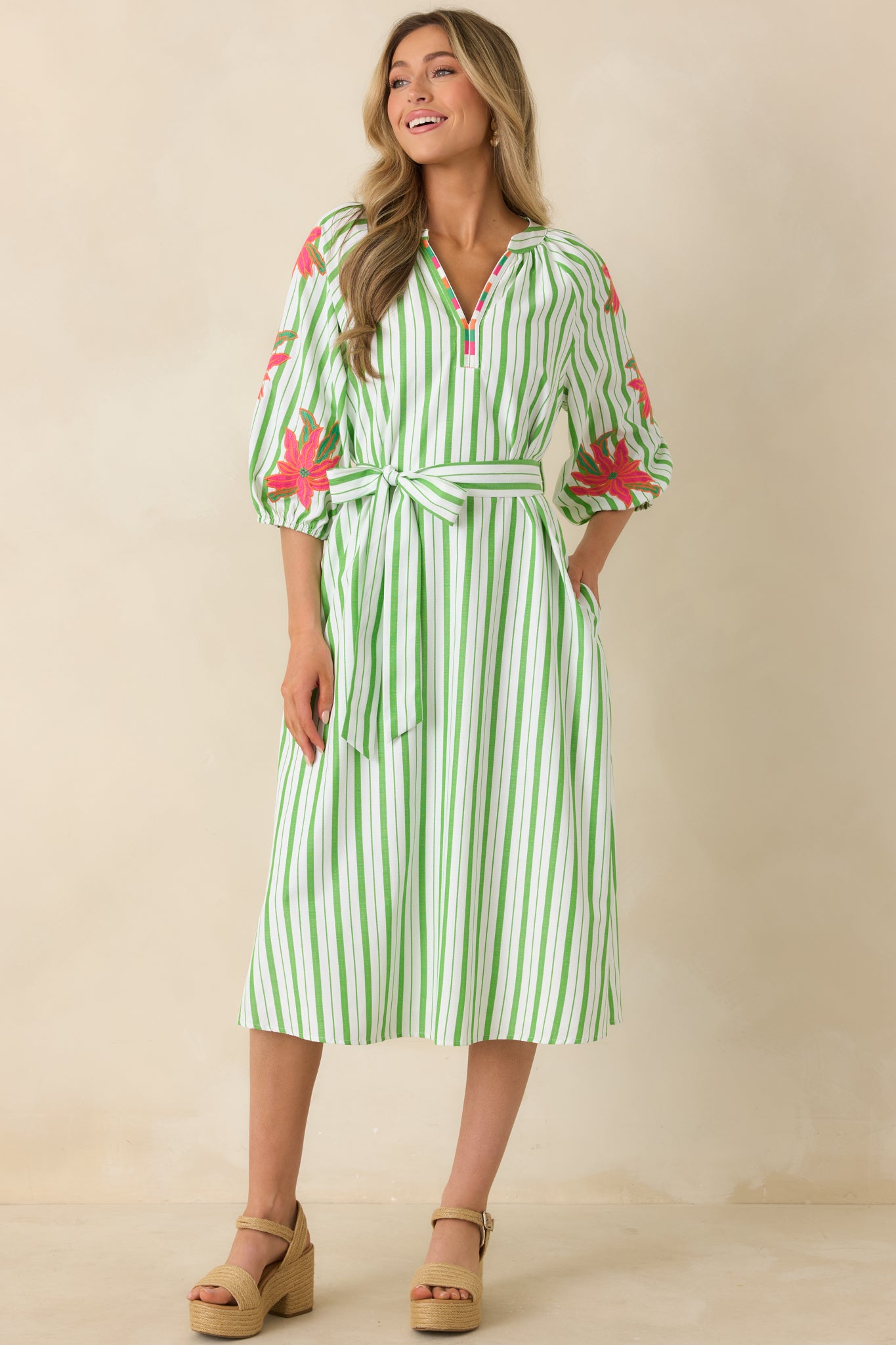 Striped floral midi dress with defined waist tie and subtle neckline detail.