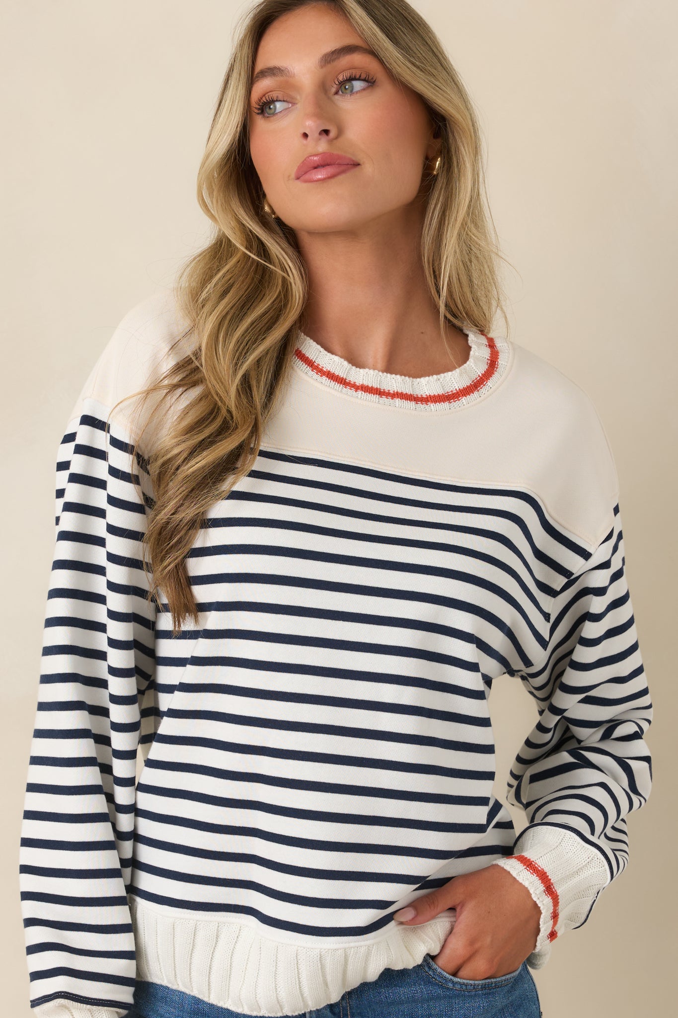 Dropped shoulders and long sleeves create an easygoing silhouette on this striped ivory top.