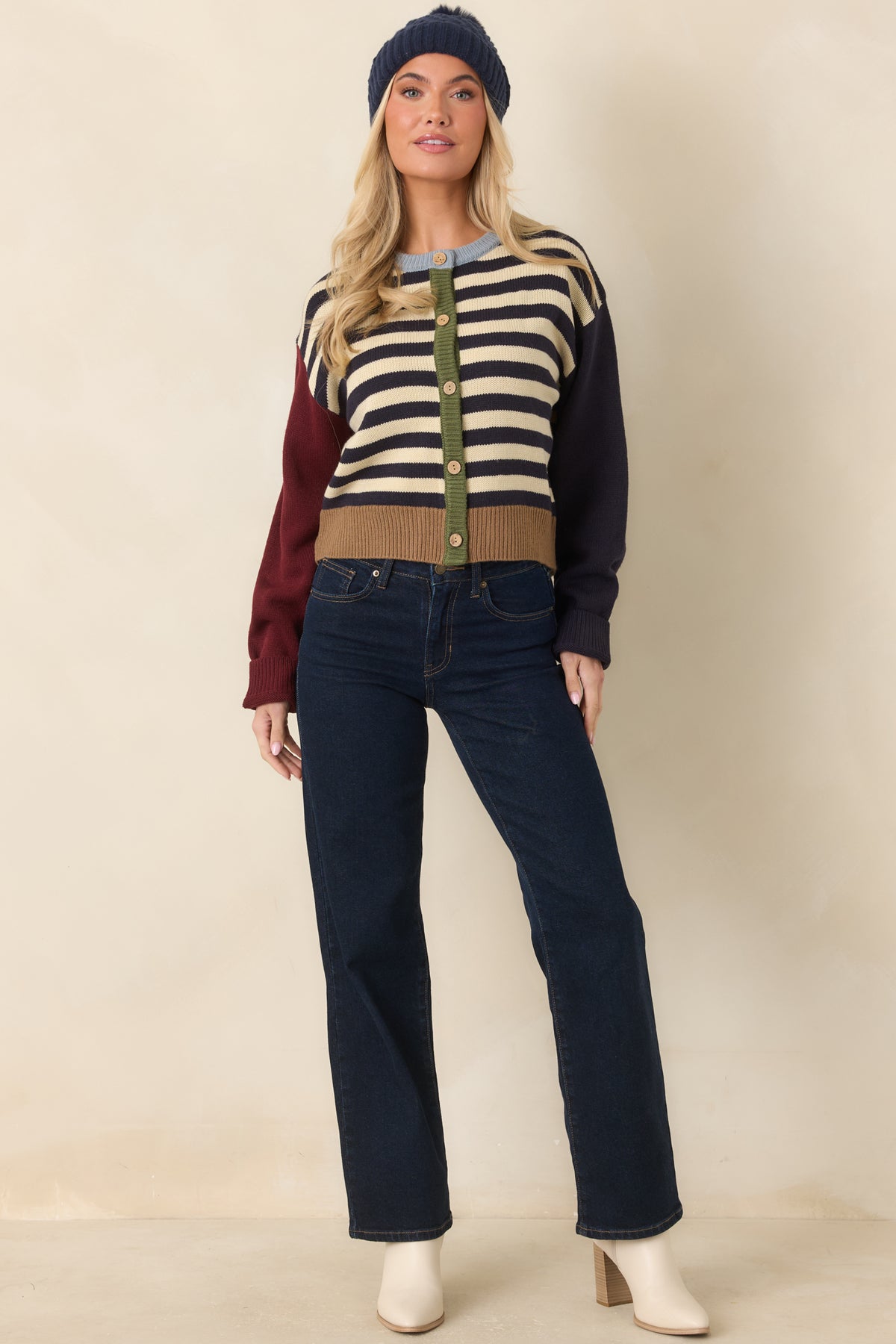 Relaxed striped cardigan featuring an olive button placket, light blue crew neckline, and neutral front buttons.