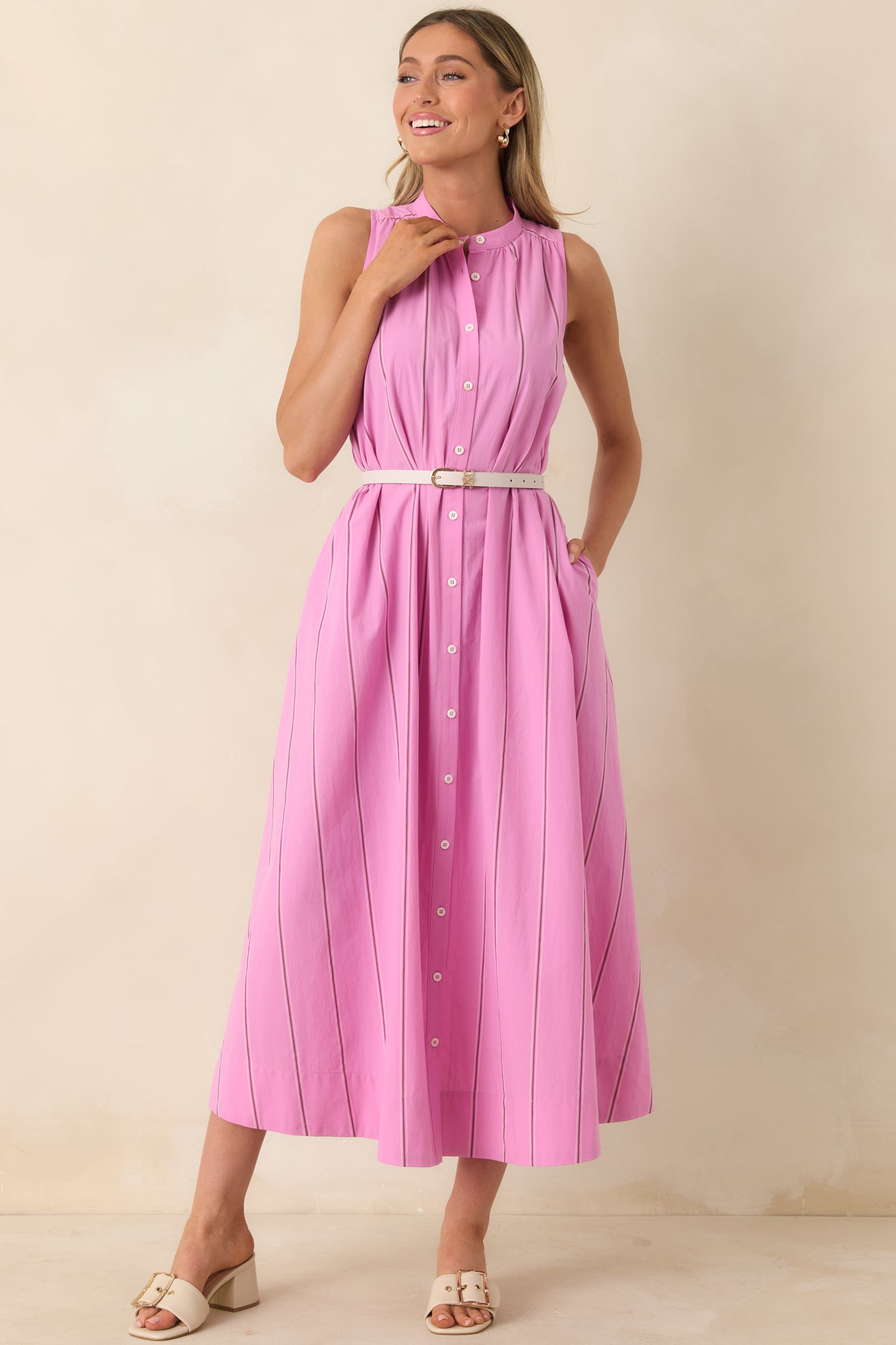 Striped maxi dress with high neckline, side pockets, and fluid movement.