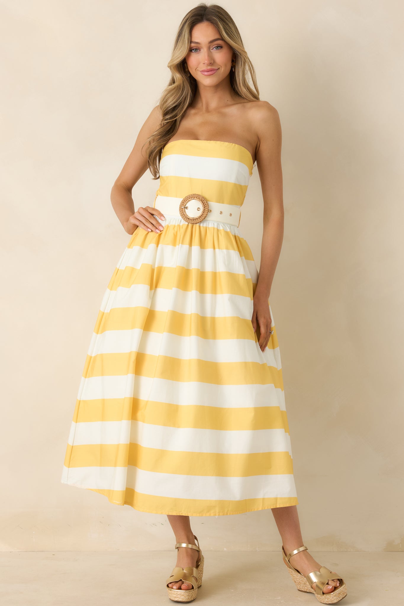 Playful striped strapless dress with midi-length skirt and soft movement.