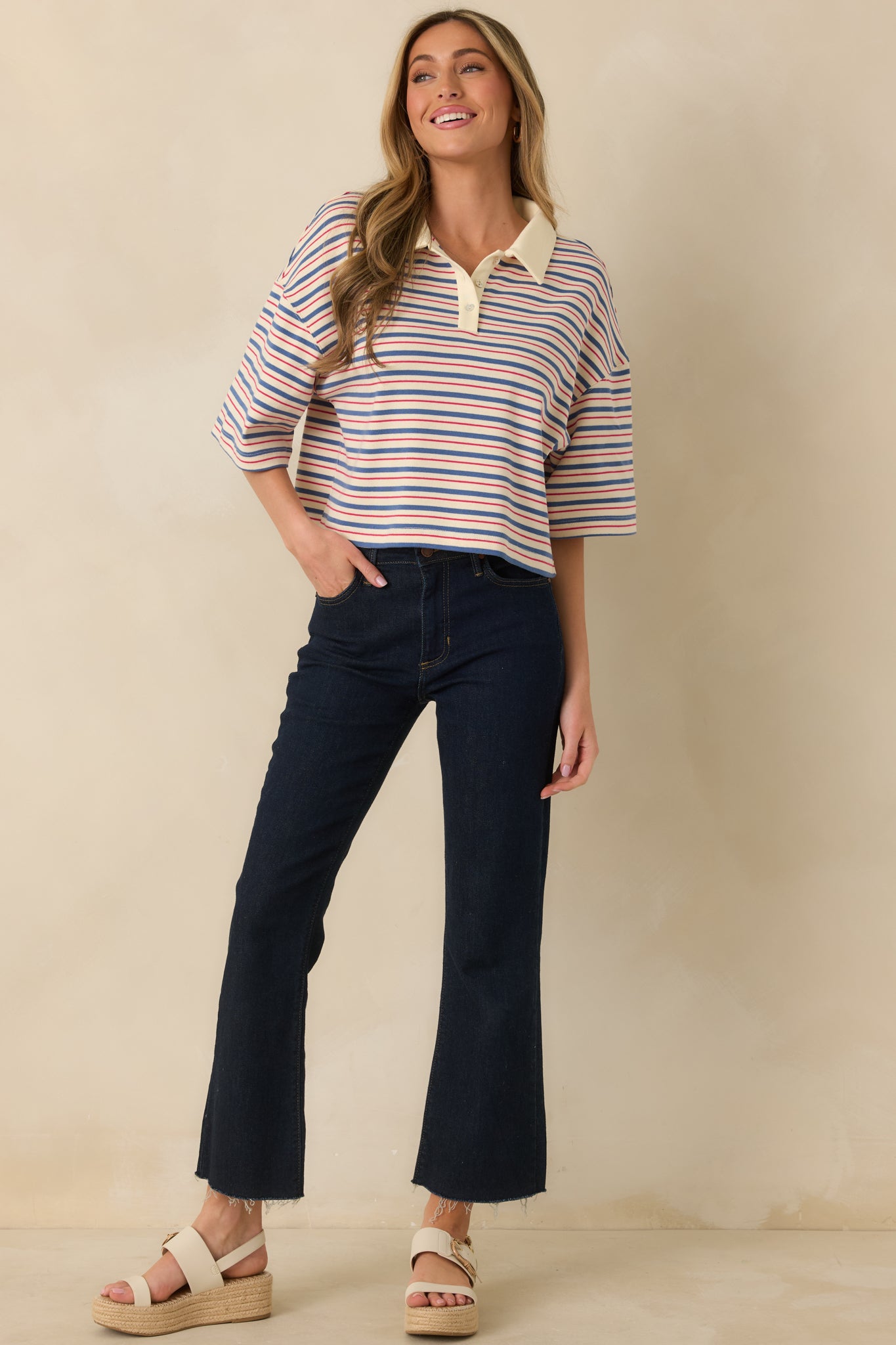 Striped top featuring contrast solid collar, partial button placket, and straight hemline.