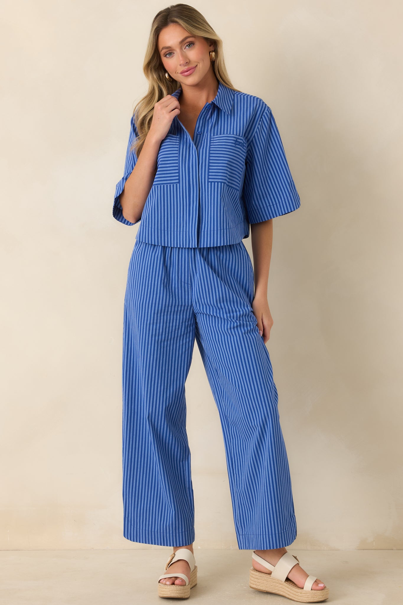 Polished striped top with elbow-length sleeves, a front patch pocket, and a comfortable everyday silhouette.
