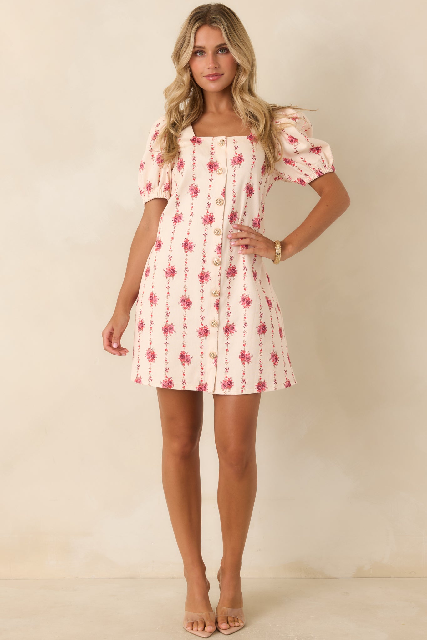 Structured cotton blend dress with an ivory floral pattern, puffed short sleeves, square neckline, and practical side pockets.