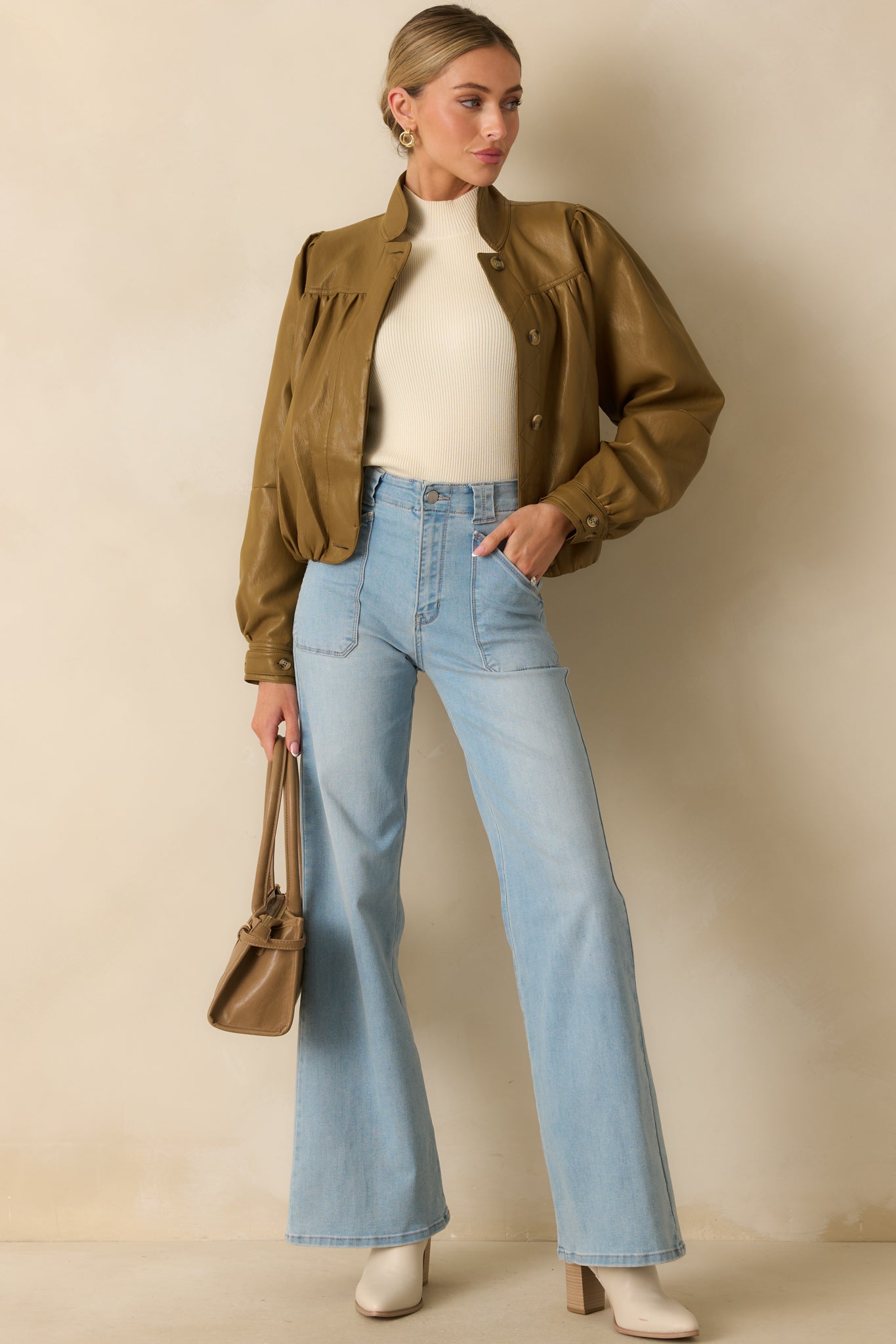 Structured faux leather jacket in olive brown showing the tailored silhouette and classic collar design.