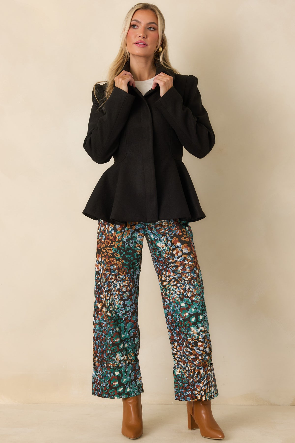 Structured felt jacket featuring curved seam detailing through the bodice and a flared peplum hem.