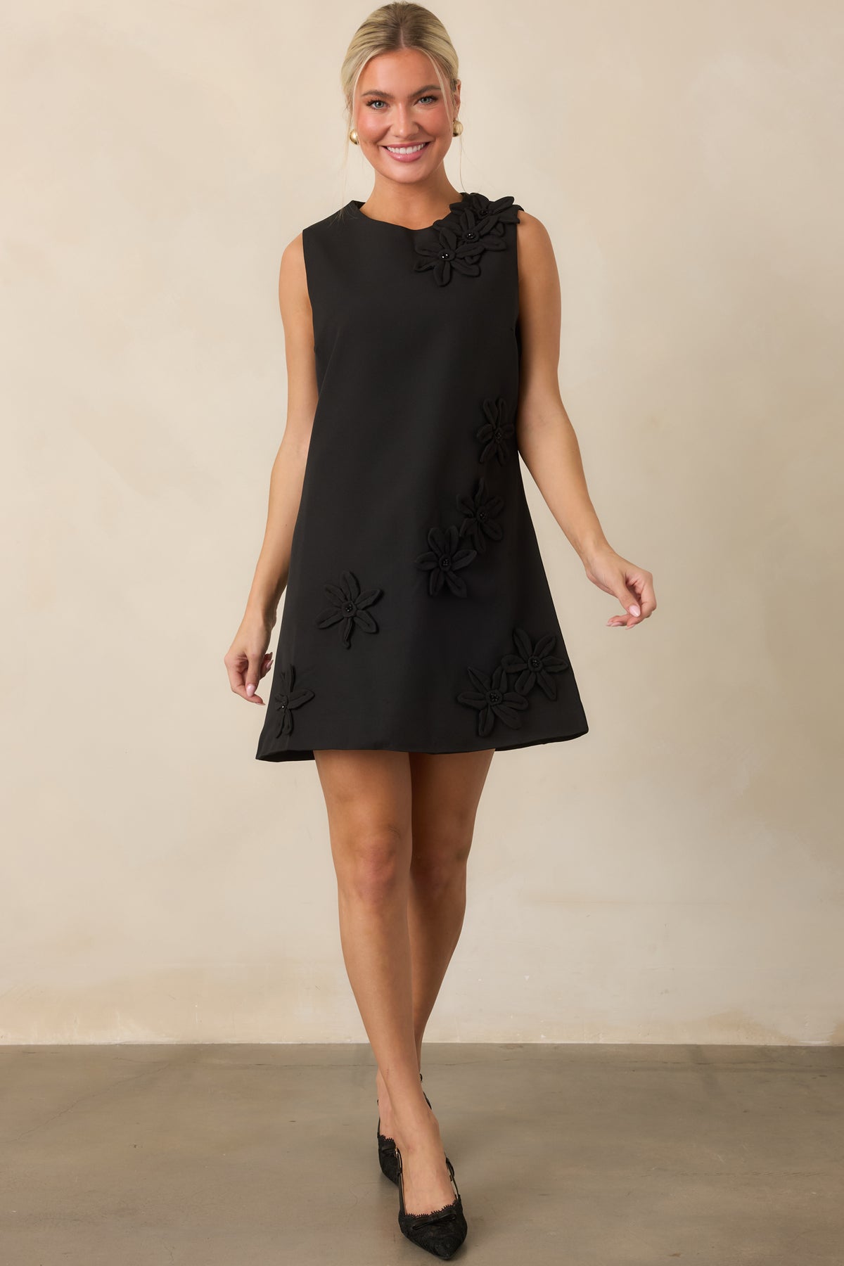 Structured mini dress featuring scattered dimensional flowers, a classic round neckline, and clean A-line shape.