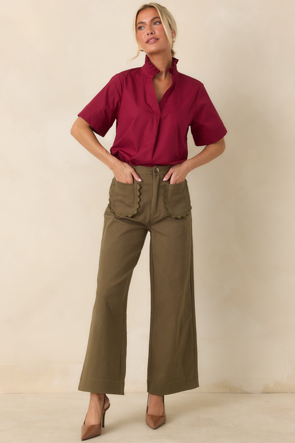 Structured olive green pants featuring breathable cotton fabric, belt loops, and a timeless wide leg design.