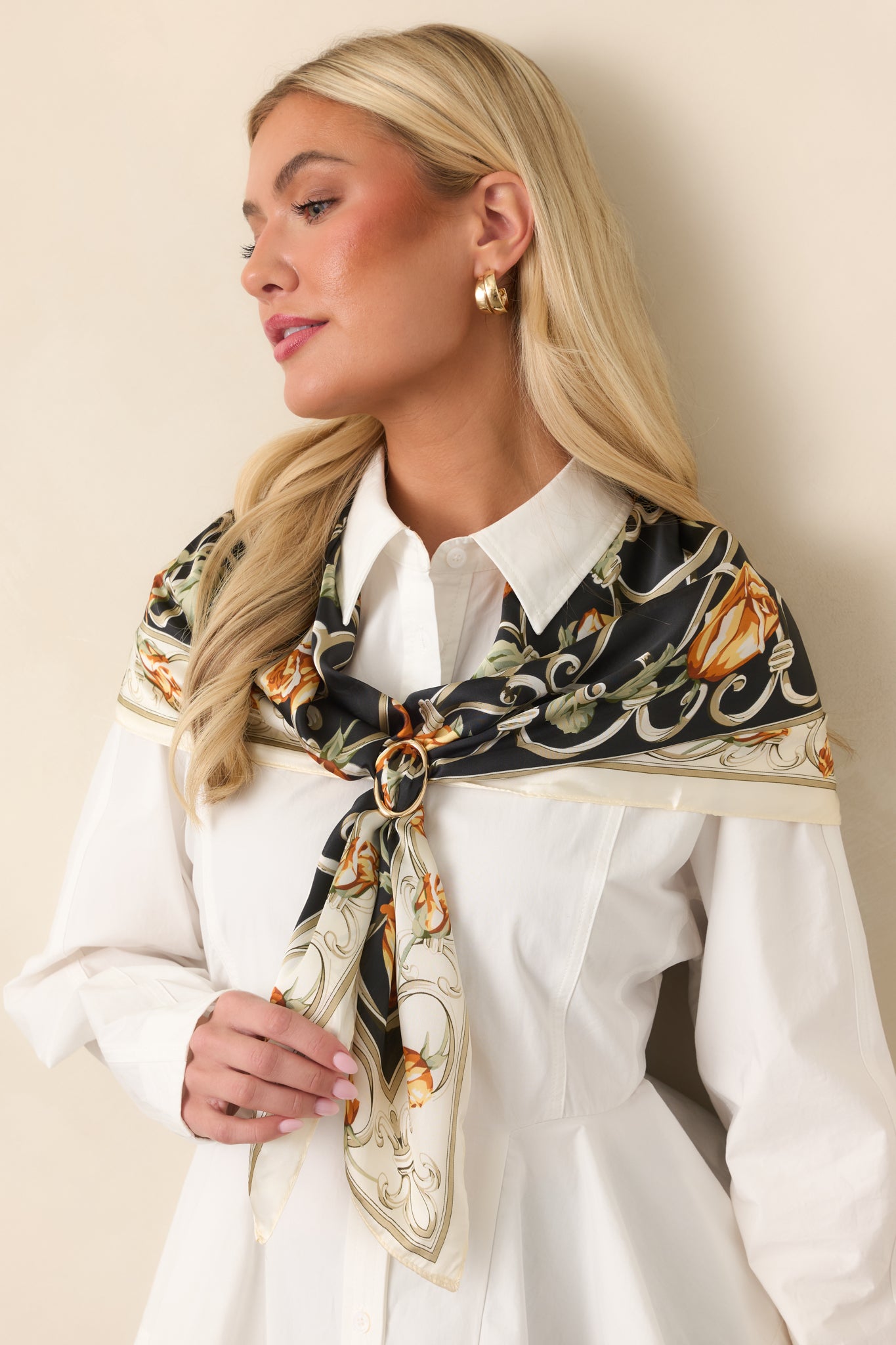 Structured peplum top displaying its crisp cotton fabric, button-front closure, and softly flared hem.