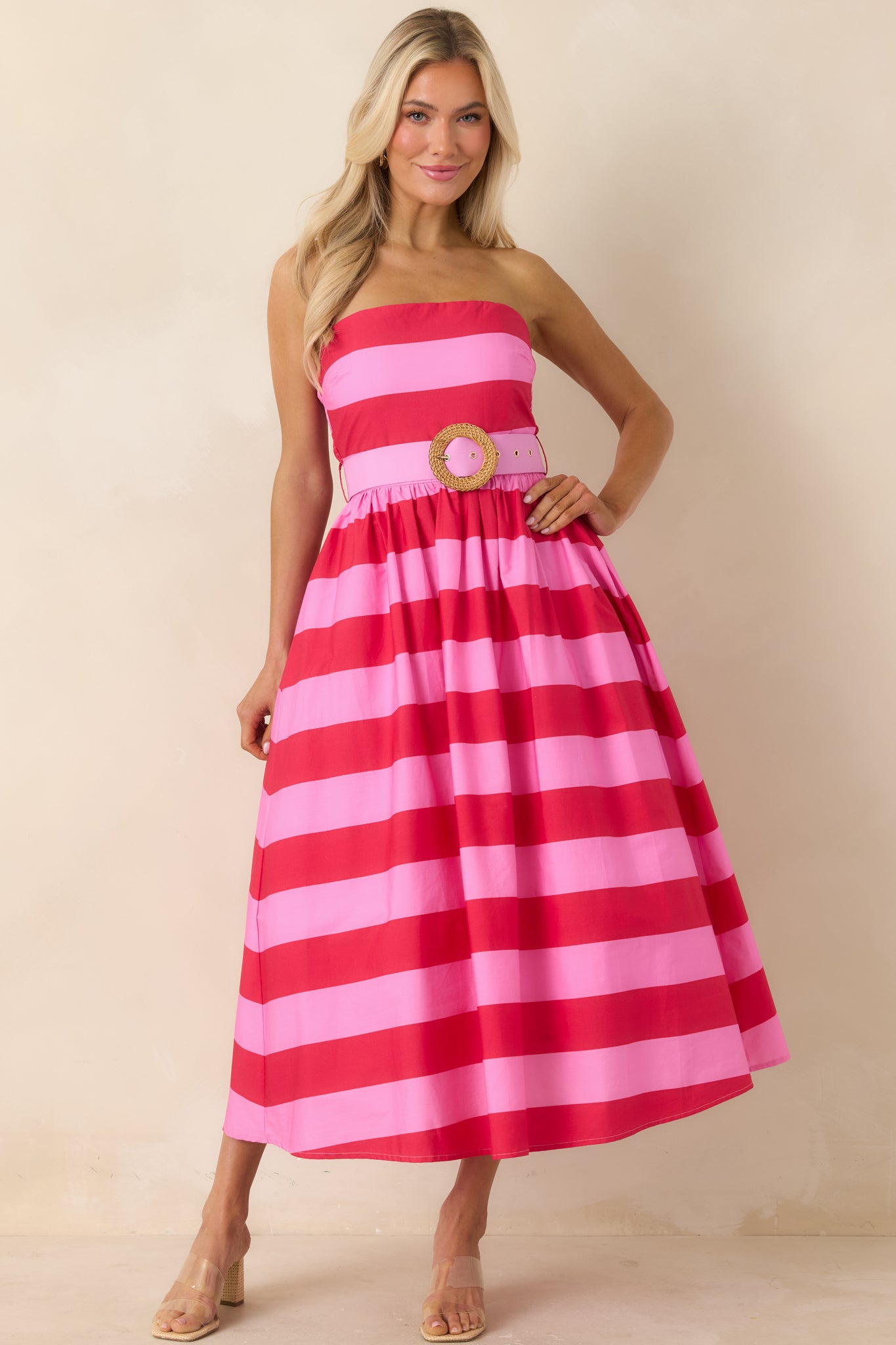 Structured strapless dress with eye-catching stripes and defined waist.