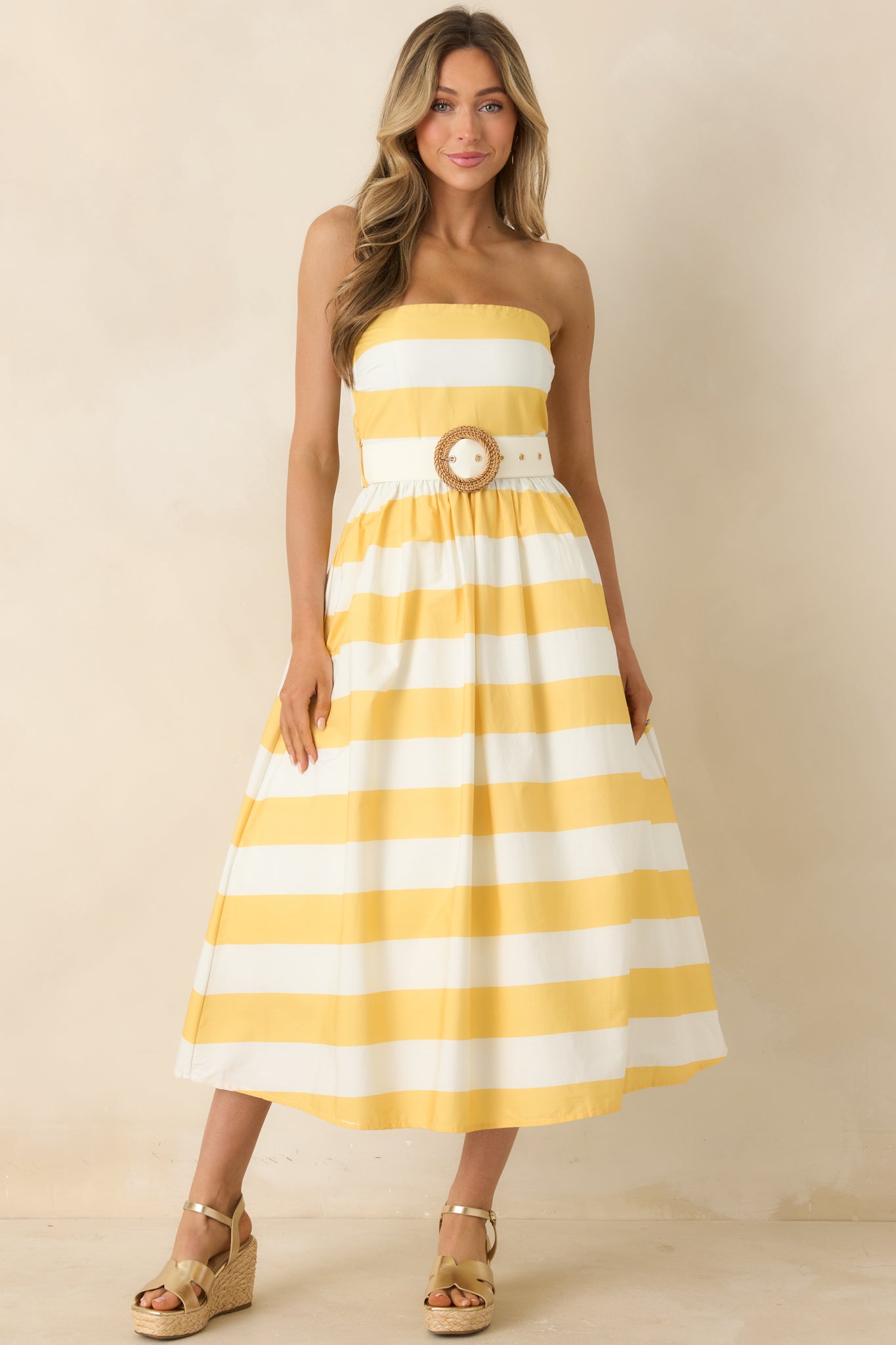 Structured strapless dress with vibrant stripes and defined waist accent.