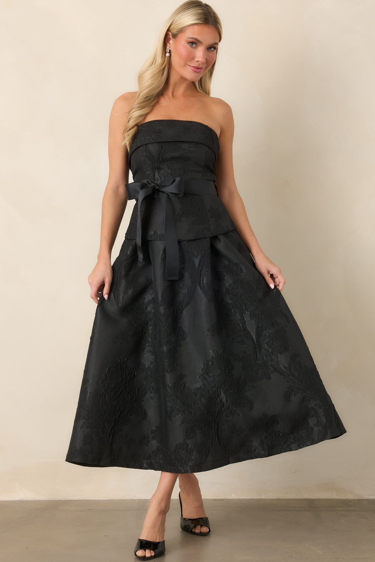 Structured strapless midi dress with a dramatic grosgrain bow and voluminous pleated A-line skirt.