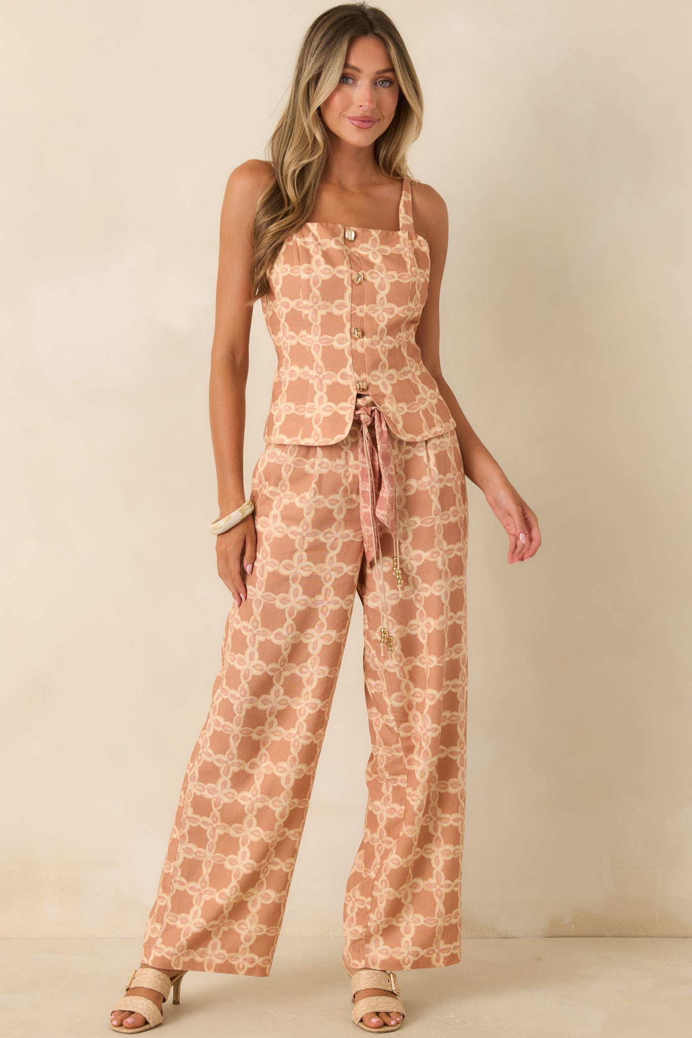 Structured tan and ivory printed top with a square neckline, decorative front buttons, and a polished tailored design.