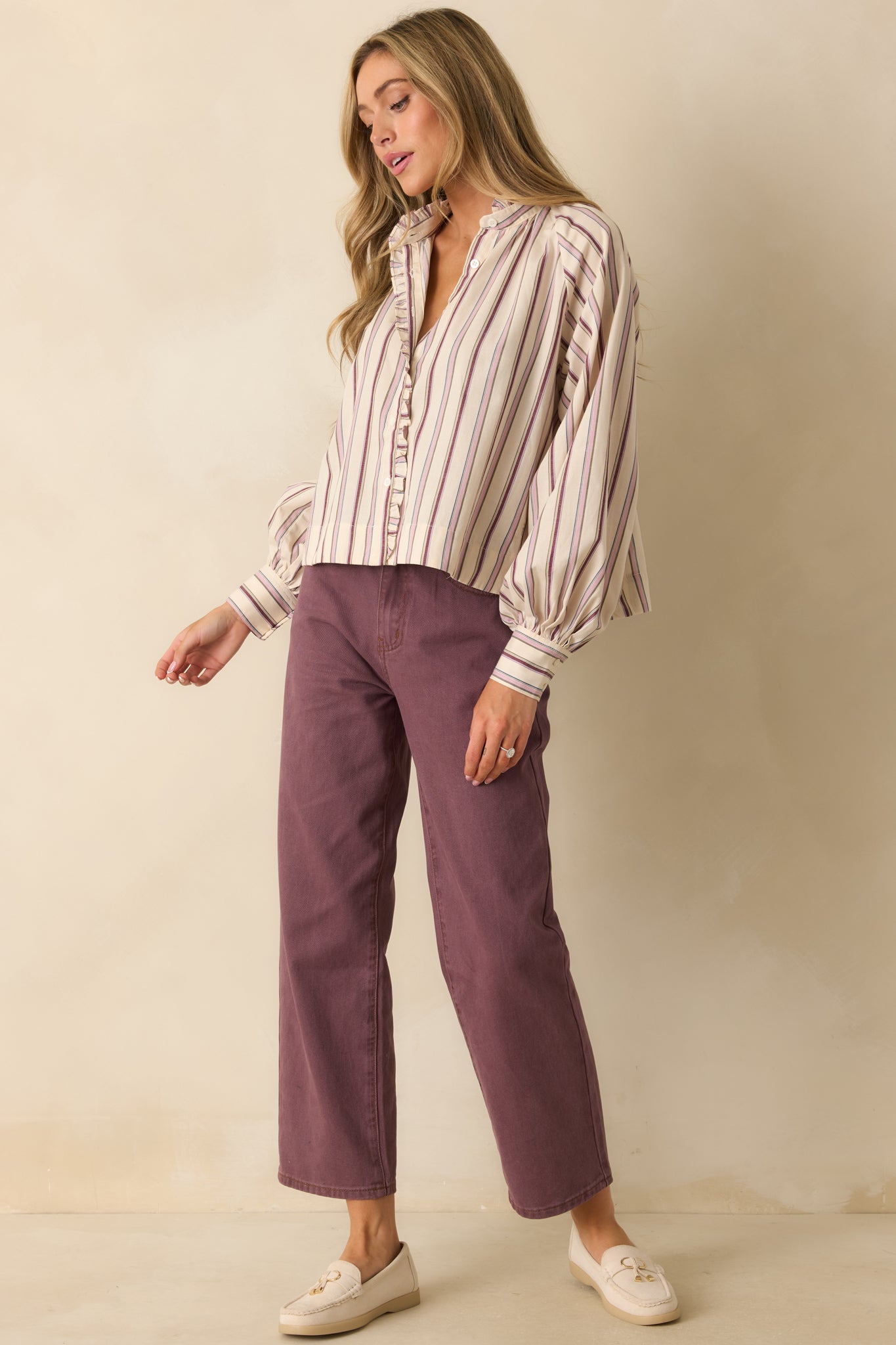 Structured violet jeans shown buttoned and zipped, emphasizing the tailored shape and smooth silhouette.