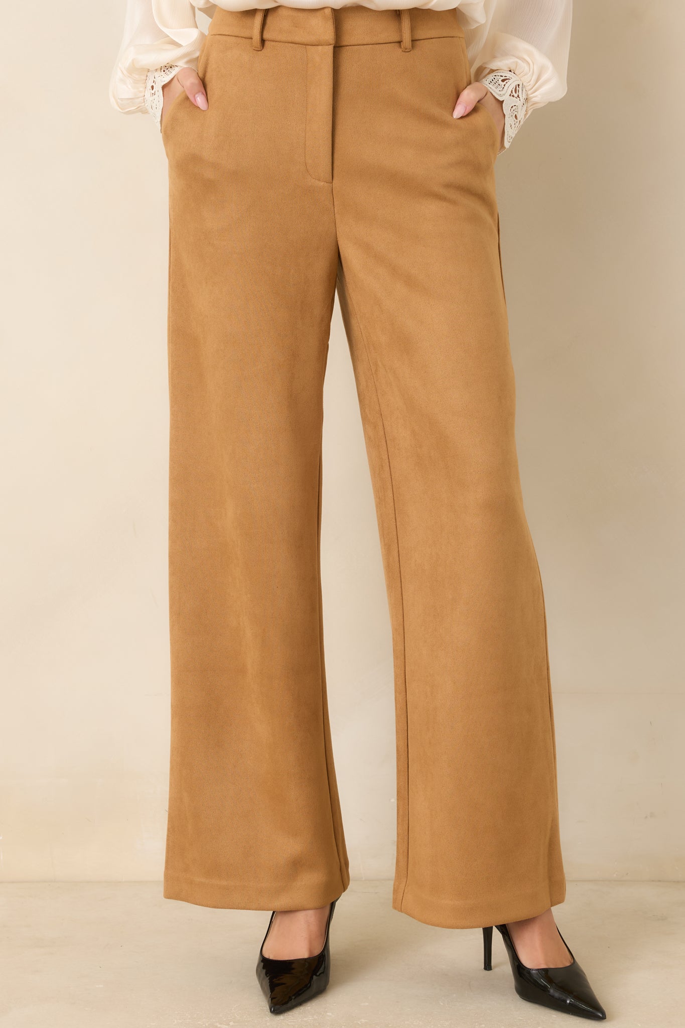 Close view of the pants highlighting the structured waistband, belt loops, concealed front closure, and side pocket design.