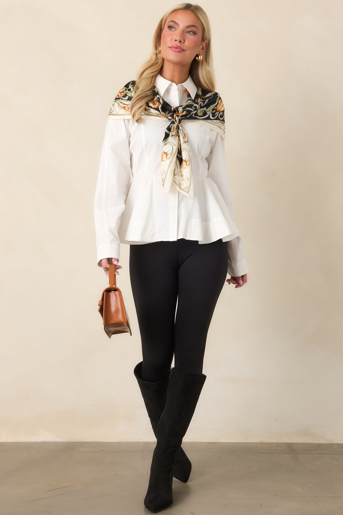 Structured white peplum top featuring a crisp button front, shaping seams, and a flared hem.